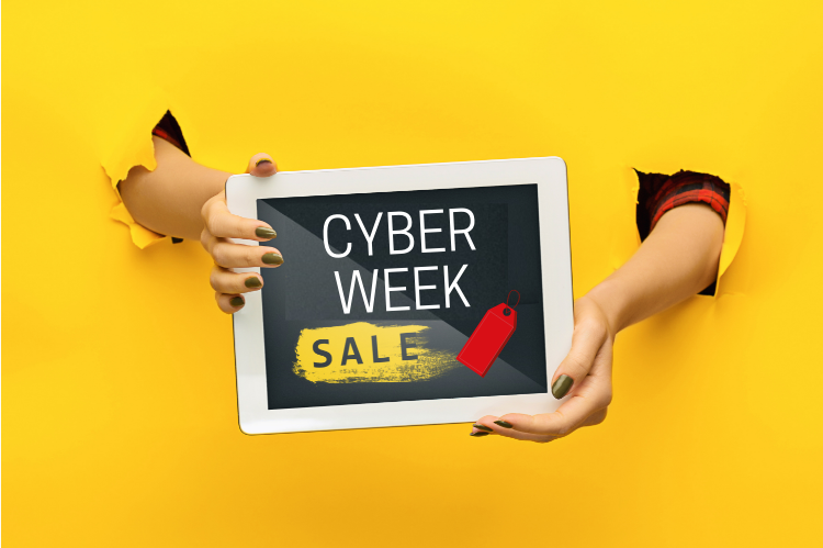 Hands holding a tablet with text that reads Cyber Week Sale with an image of a price tag