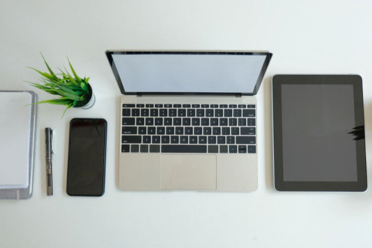 phone, laptop and tablet on a desk