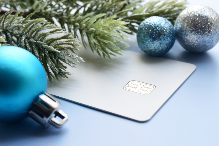 A credit card for retail sales with holiday decor around it