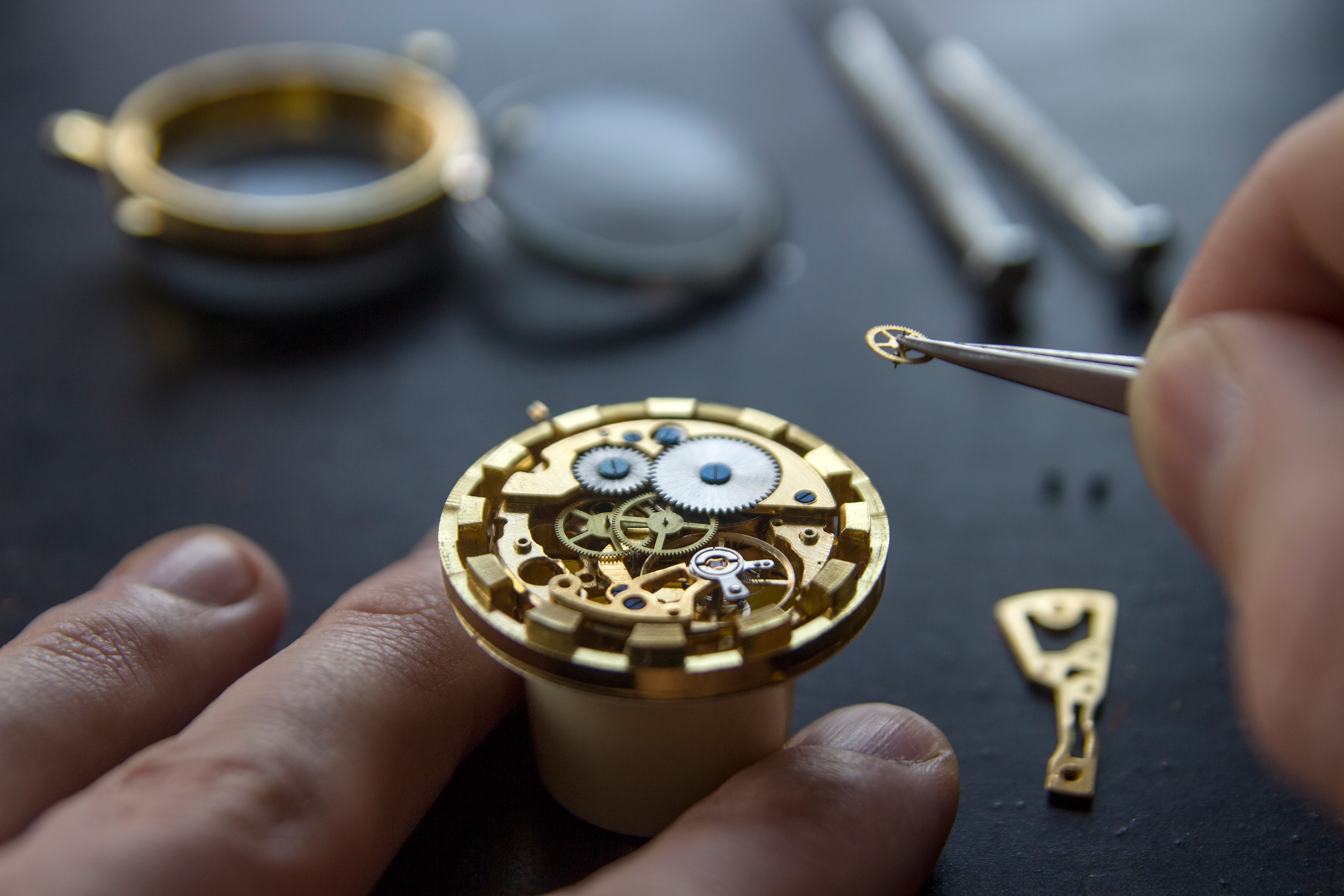 Person repairing a gold watch