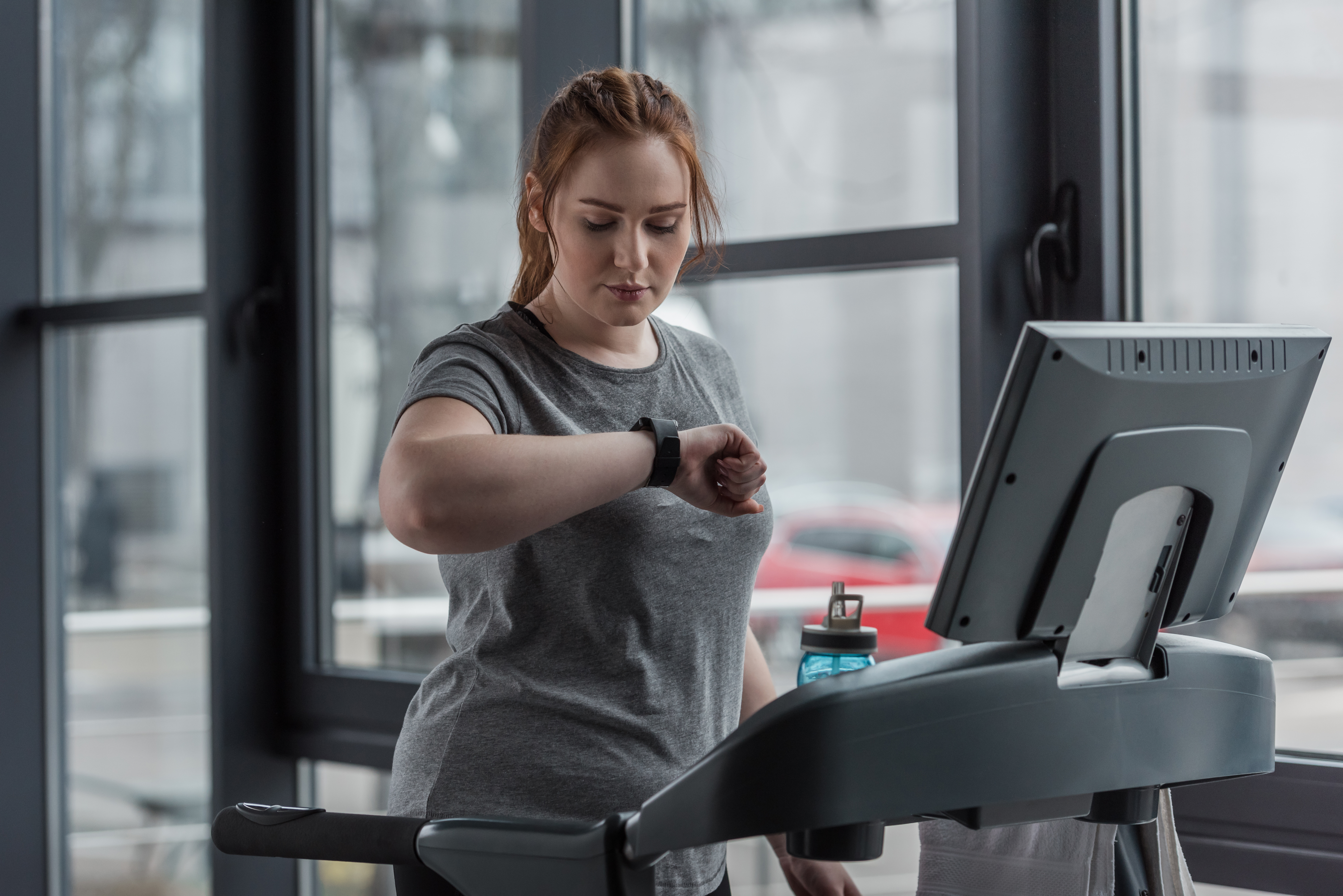 woman on treadmill with fitness tracker