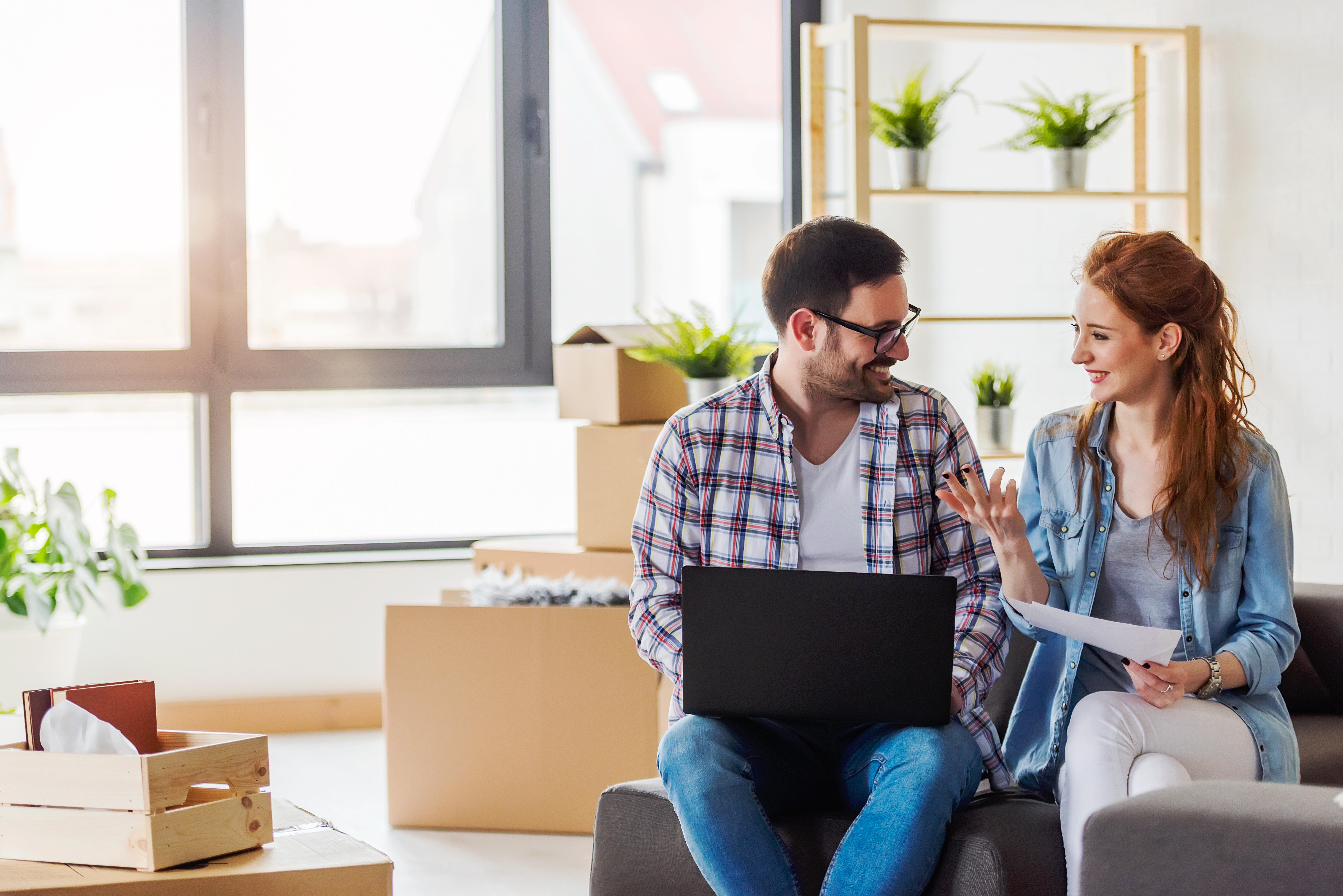 Man and woman smiling and looking at a computer together