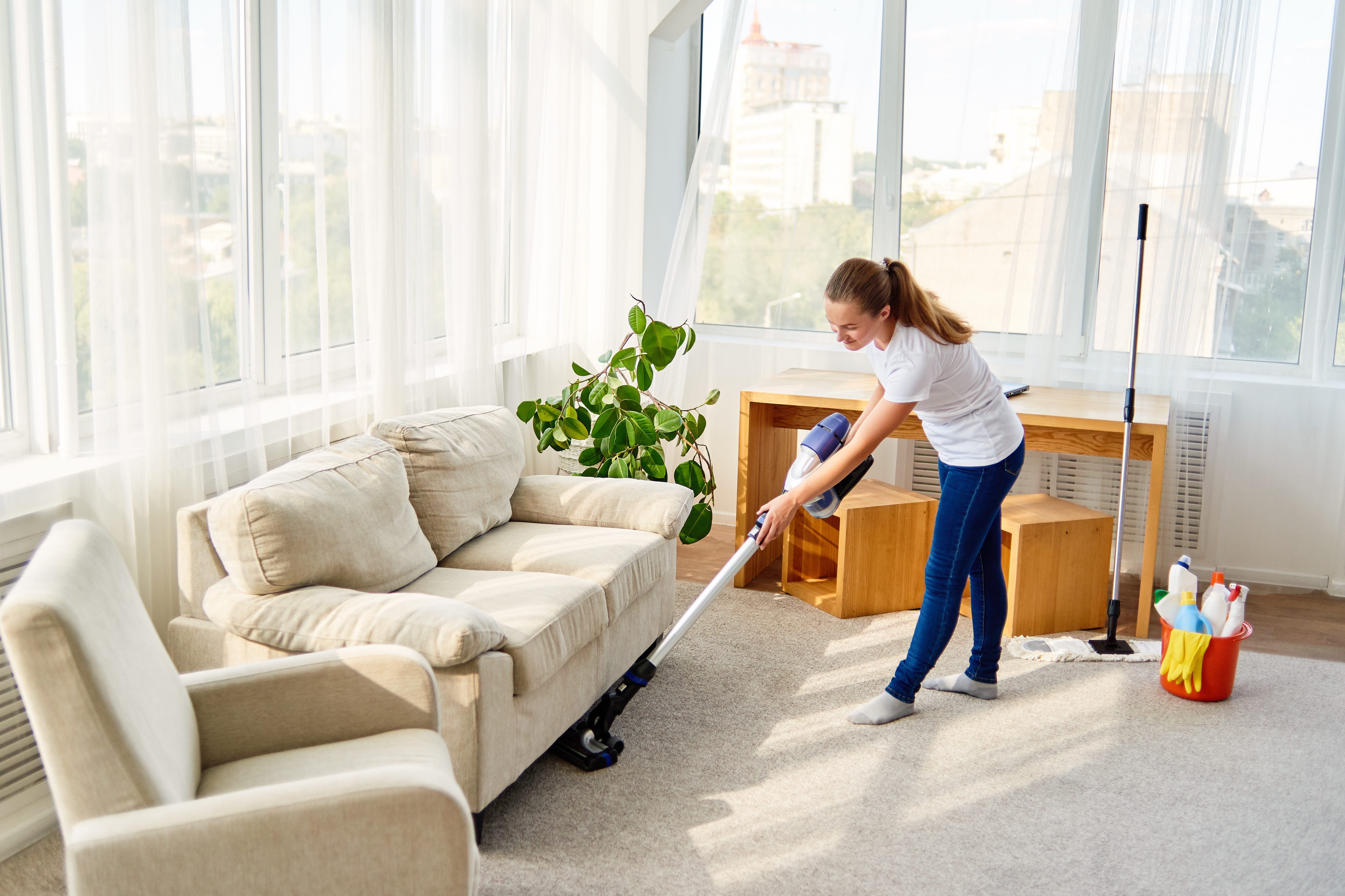 Woman vacuuming her rug