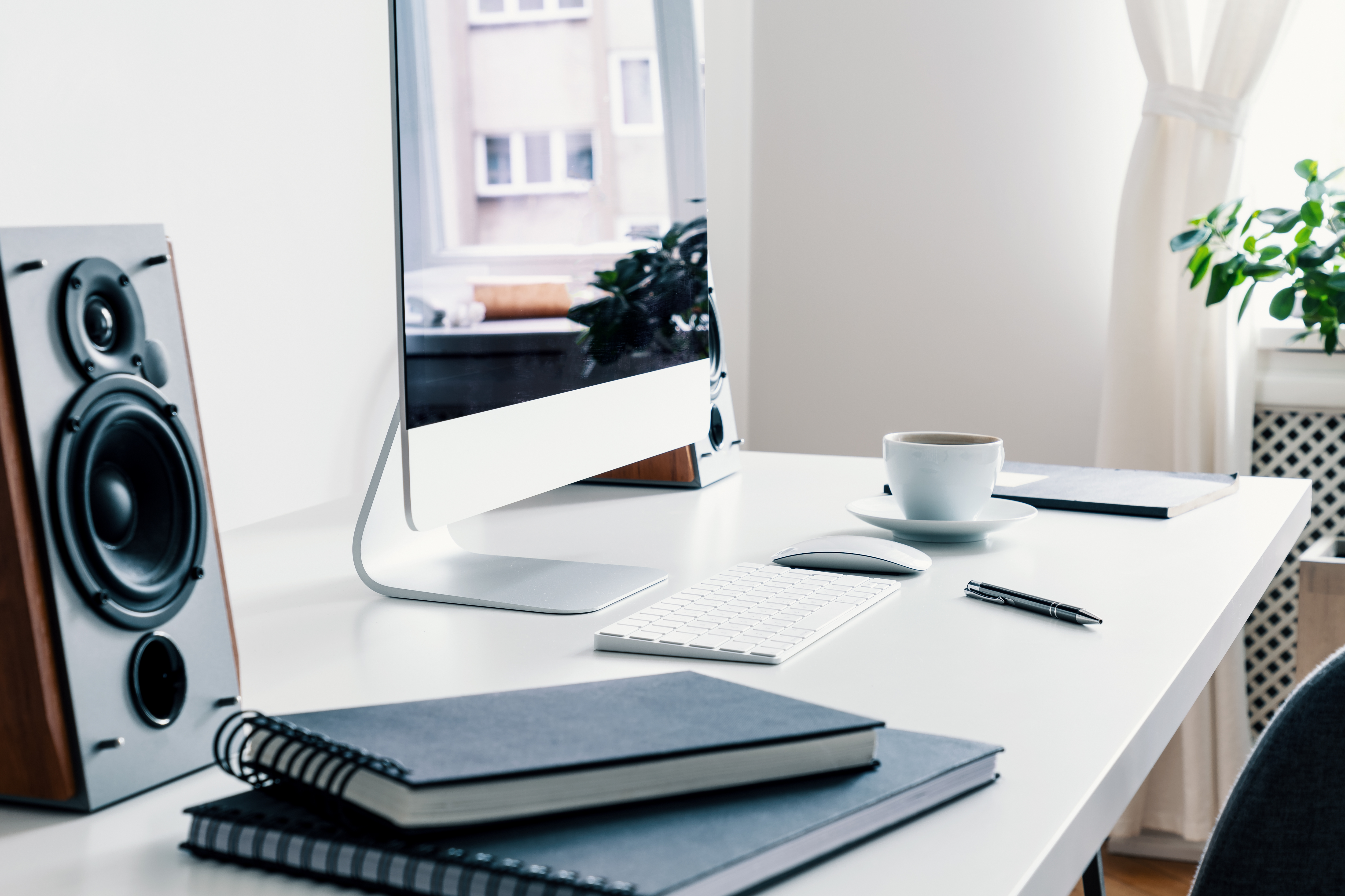 A desktop computer and speaker on a desk