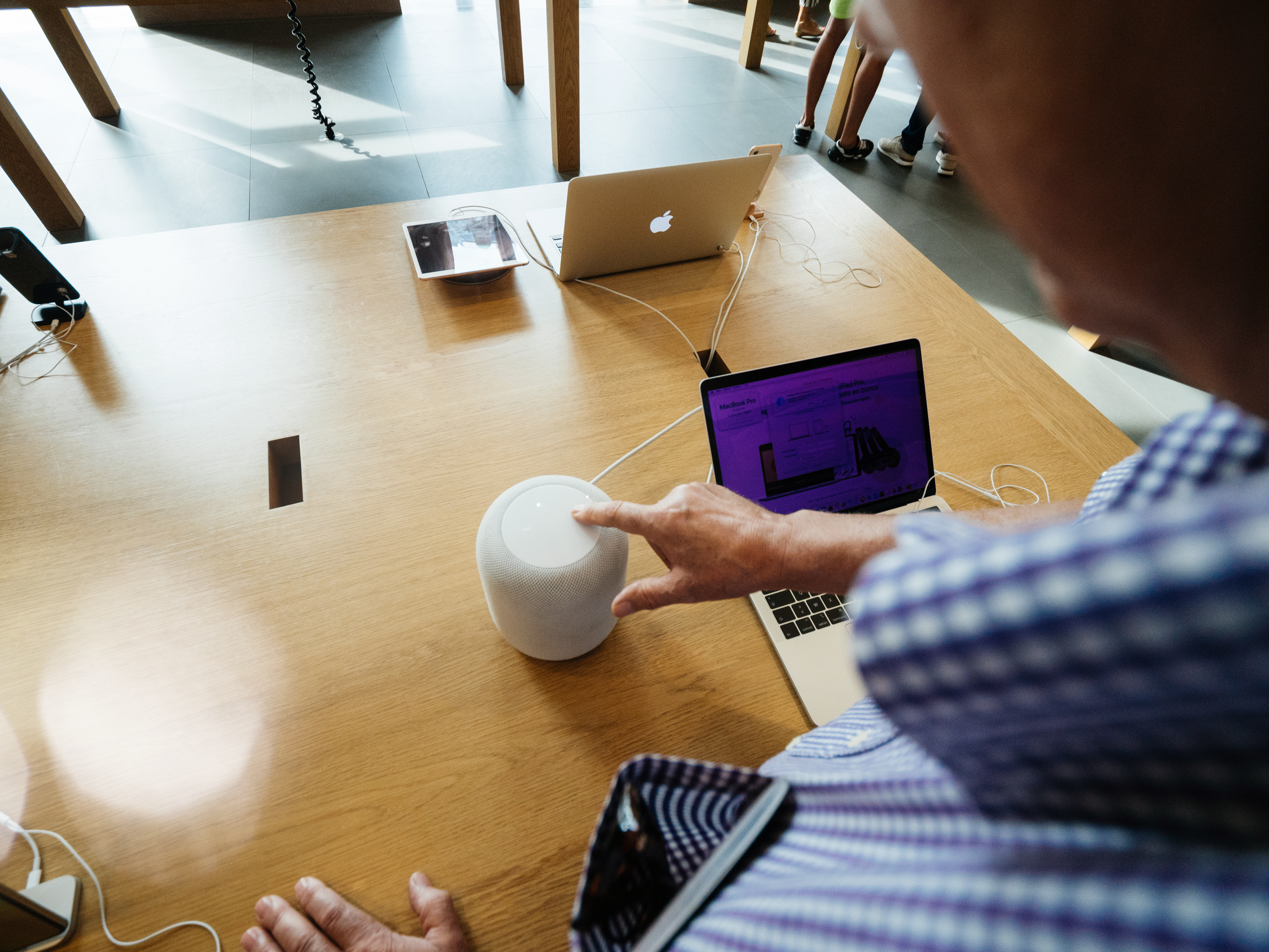 Man pressing Apple HomePod