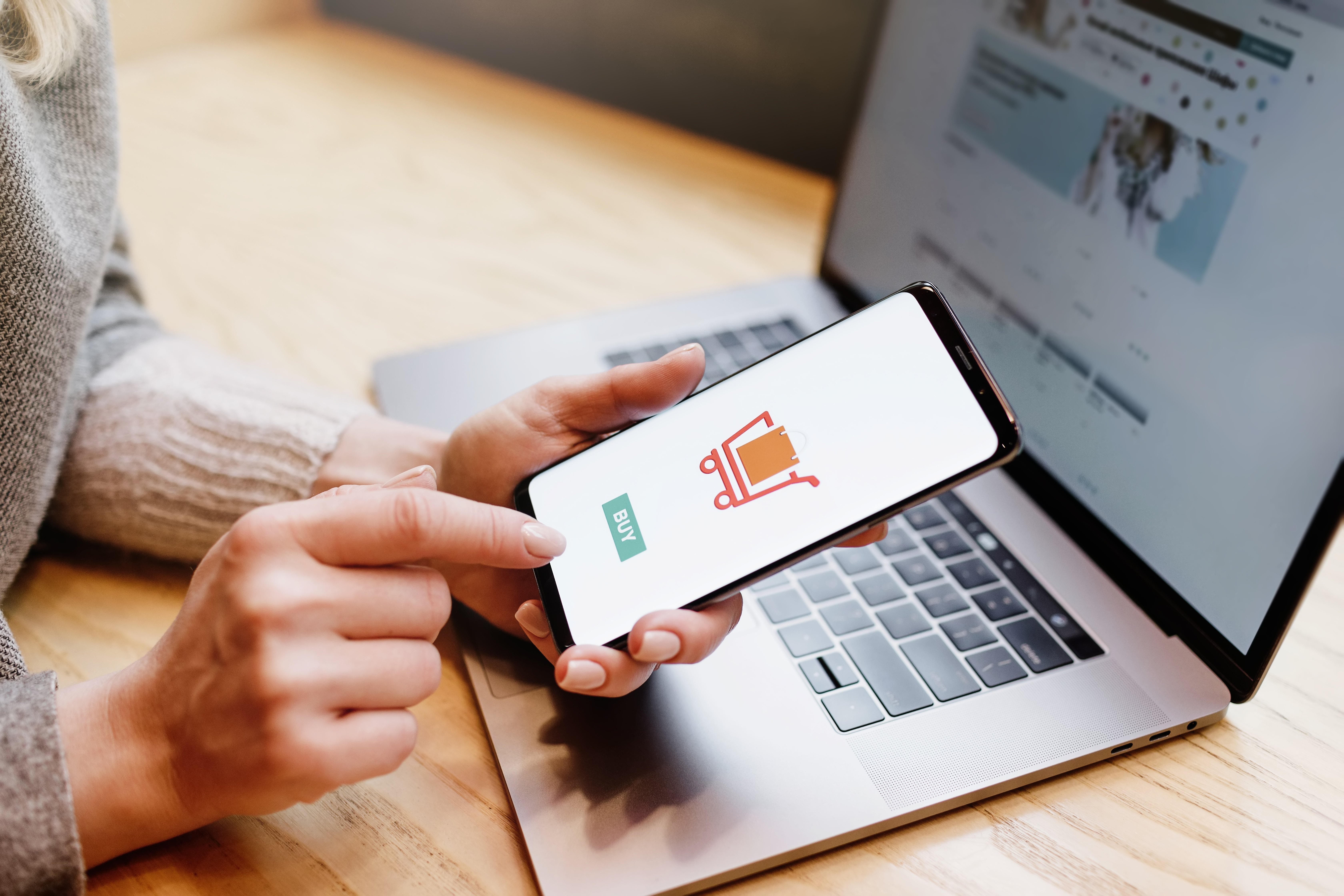 Woman using her phone to purchase an item online