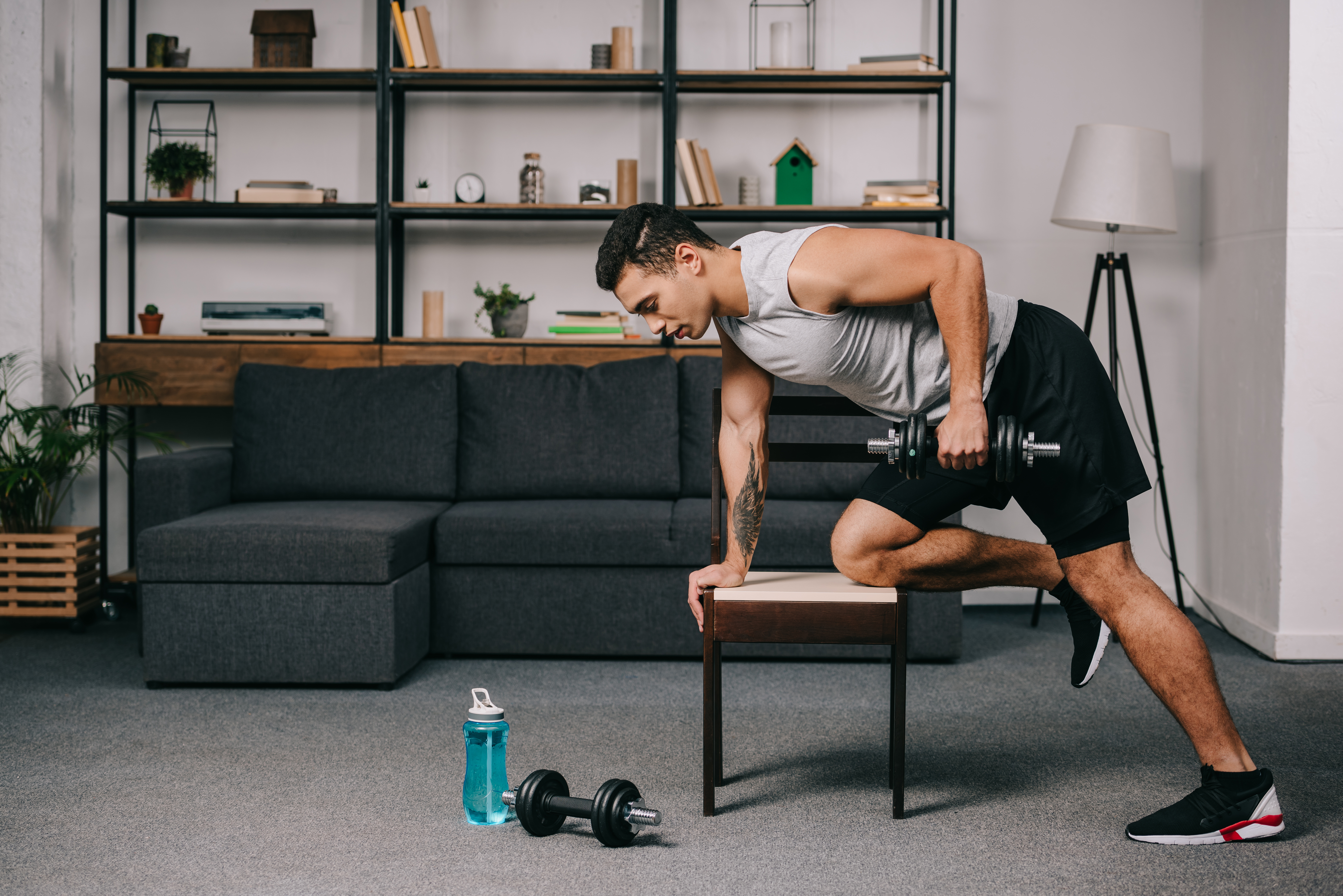 Man doing a workout with dumbbells at home