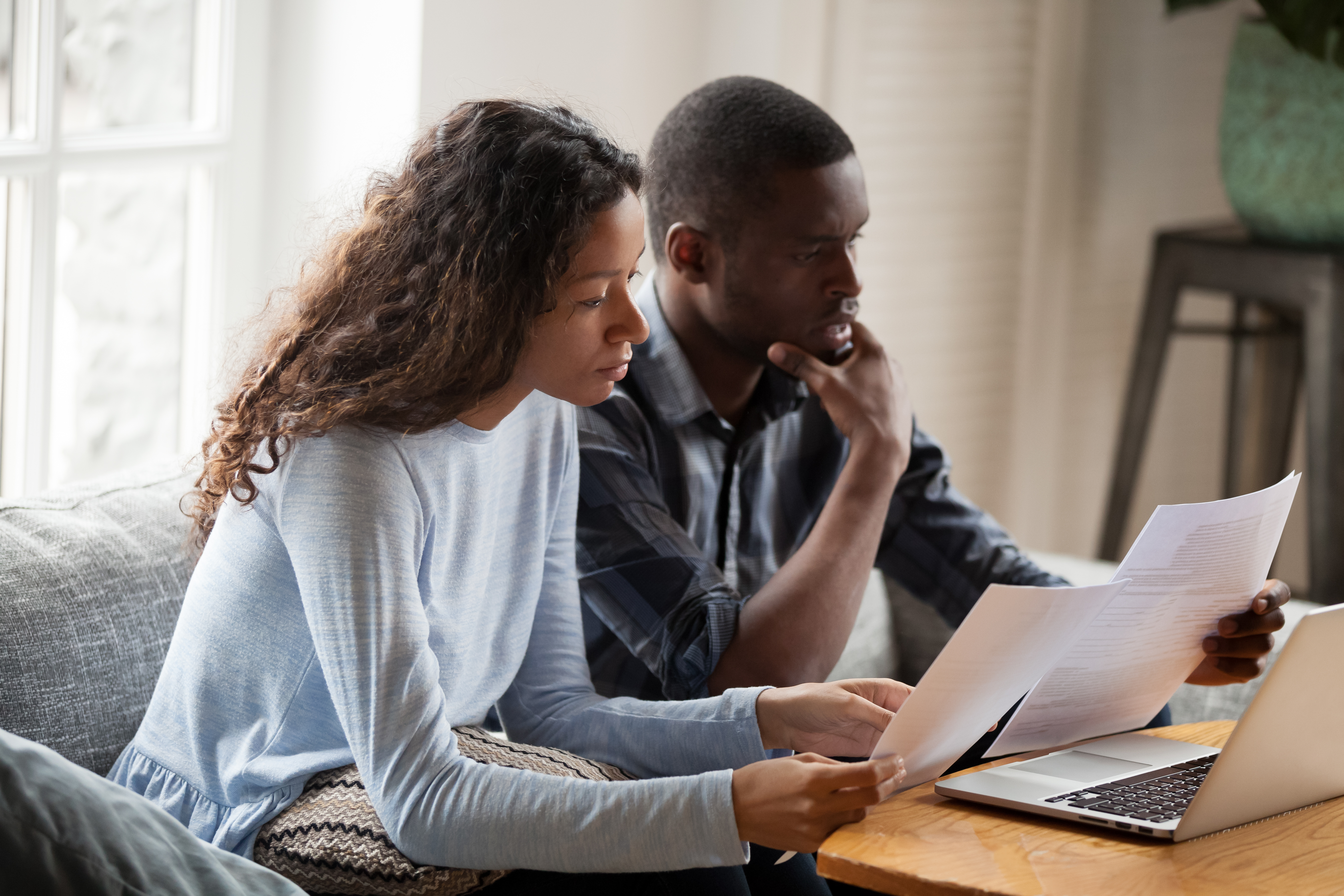 Man and woman sitting looking over papers