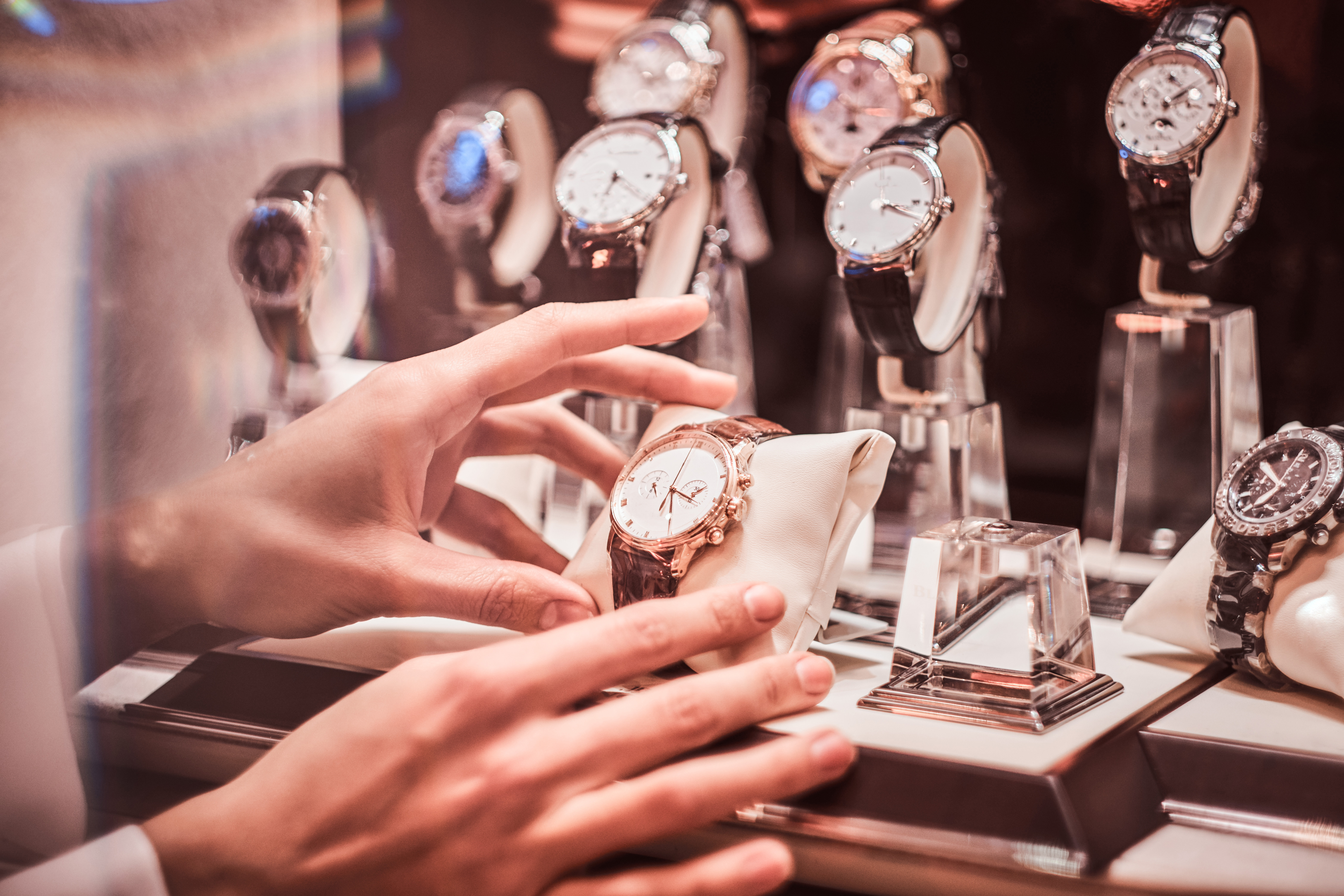 Person taking a watch from a display case