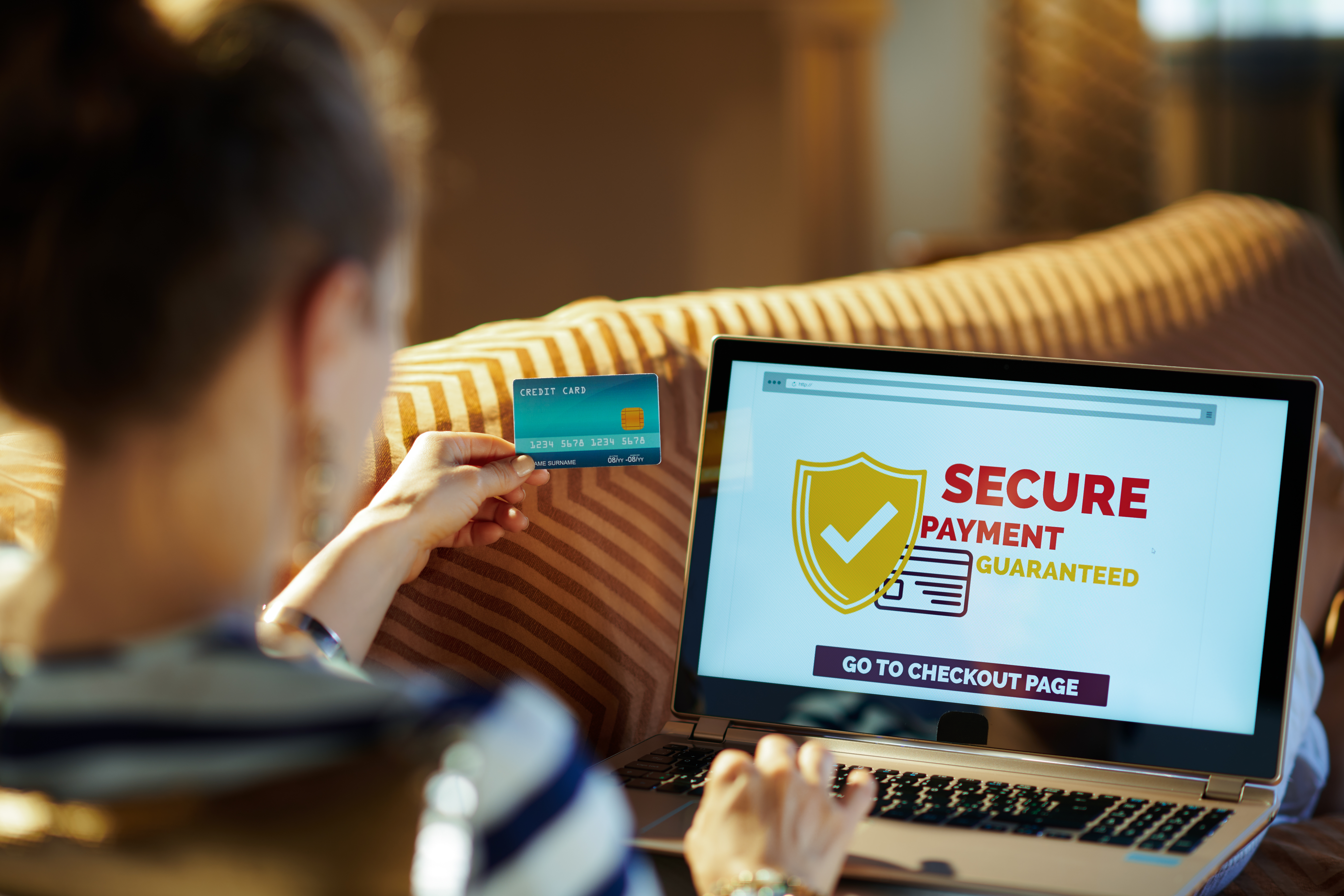 Woman using her credit card to shop online