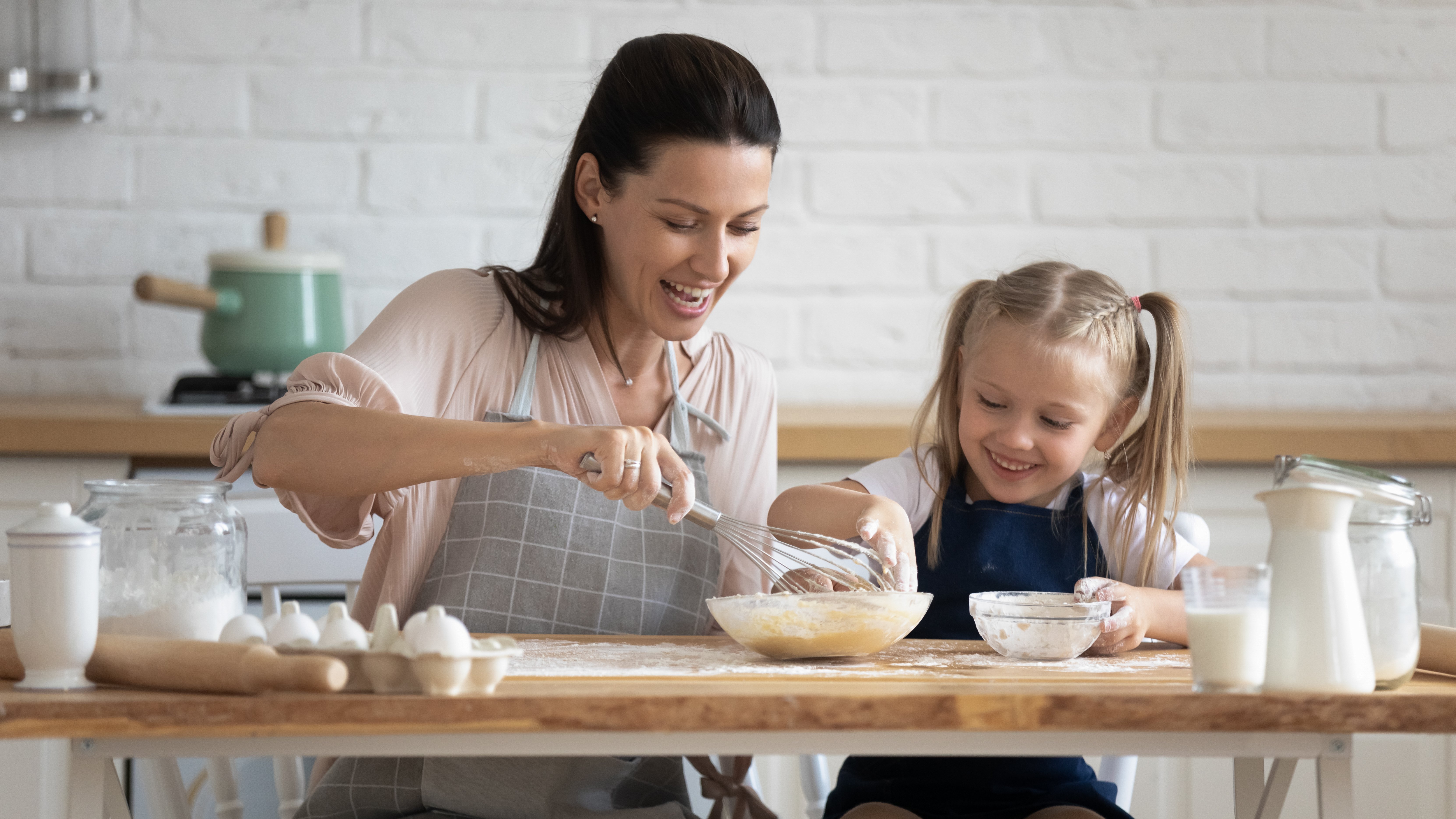 Mother and daughter baking in the kitchen