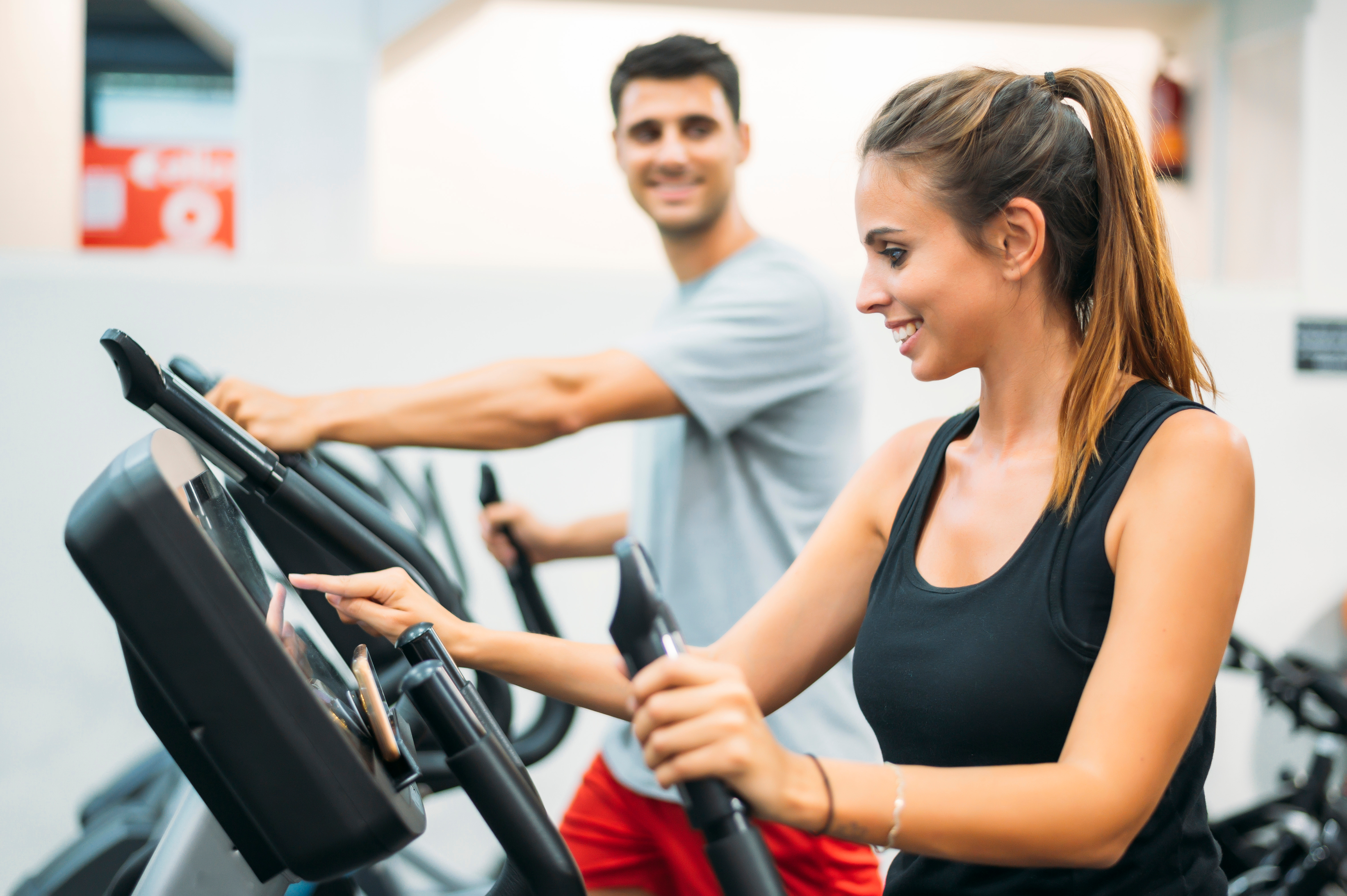 Couple using stair climber machines