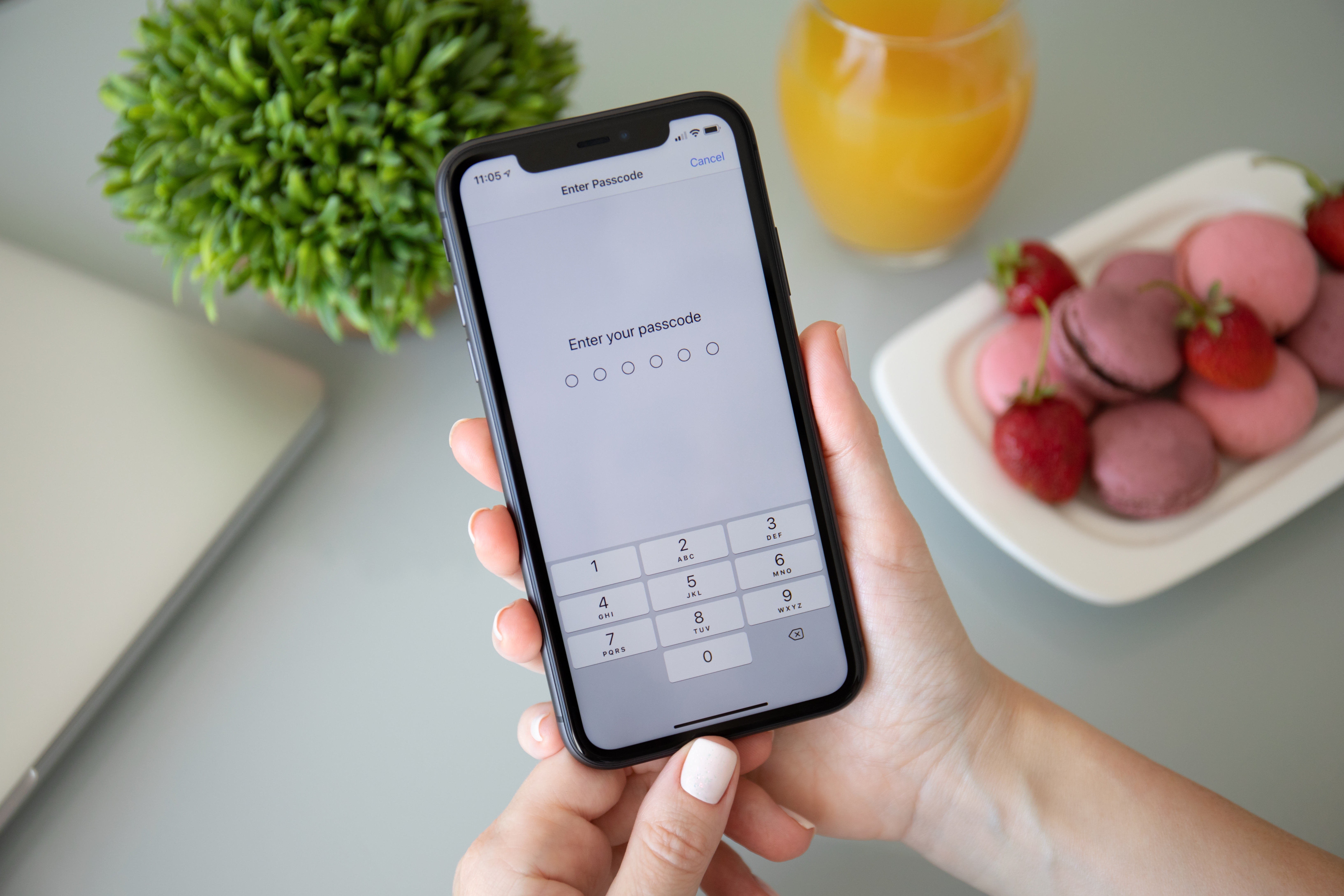 Person holding an iPhone with the lock screen on it