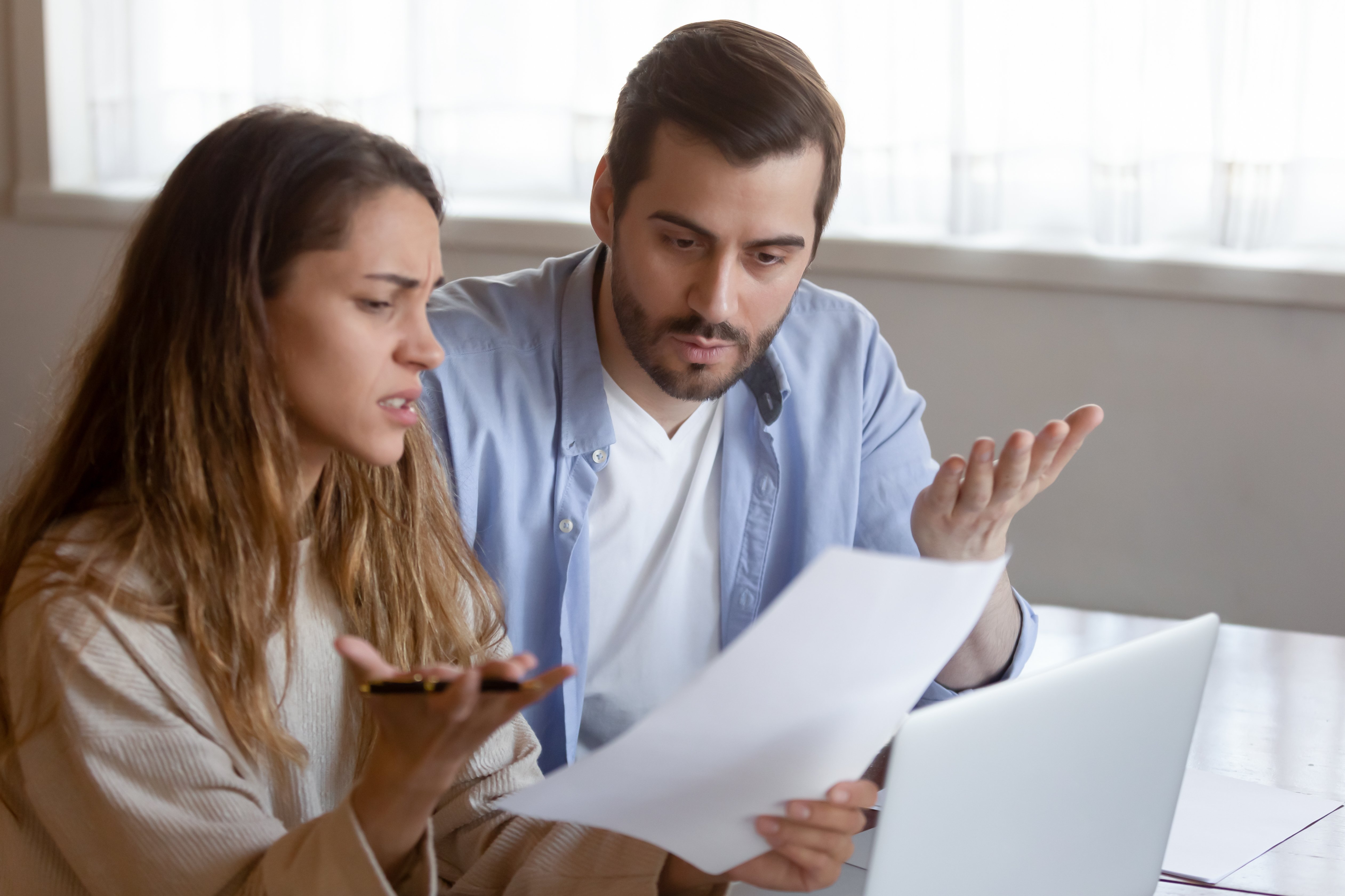 two confused people reading terms