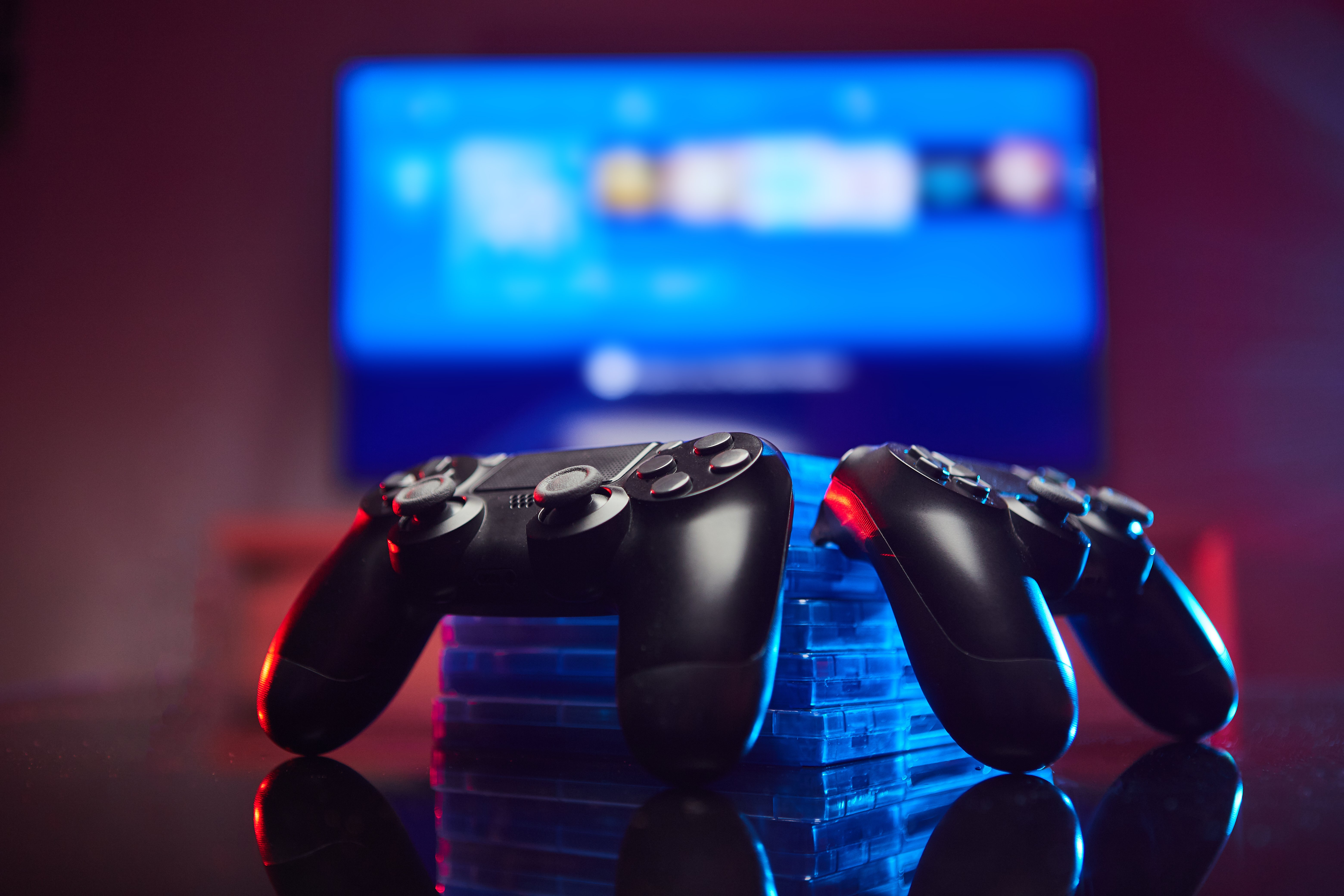 Two PlayStation controllers sitting on a table