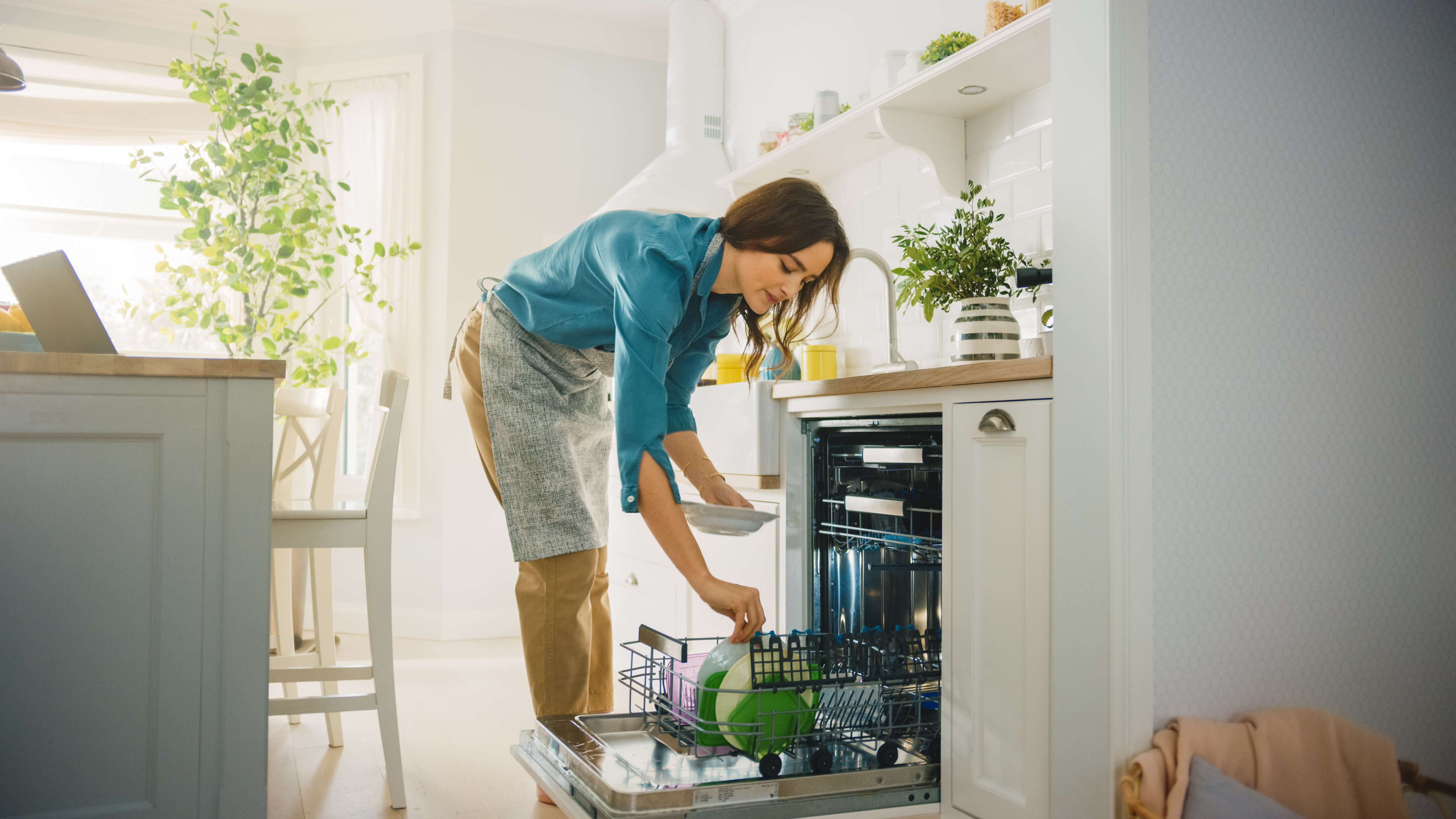 Woman loading a dishwasher