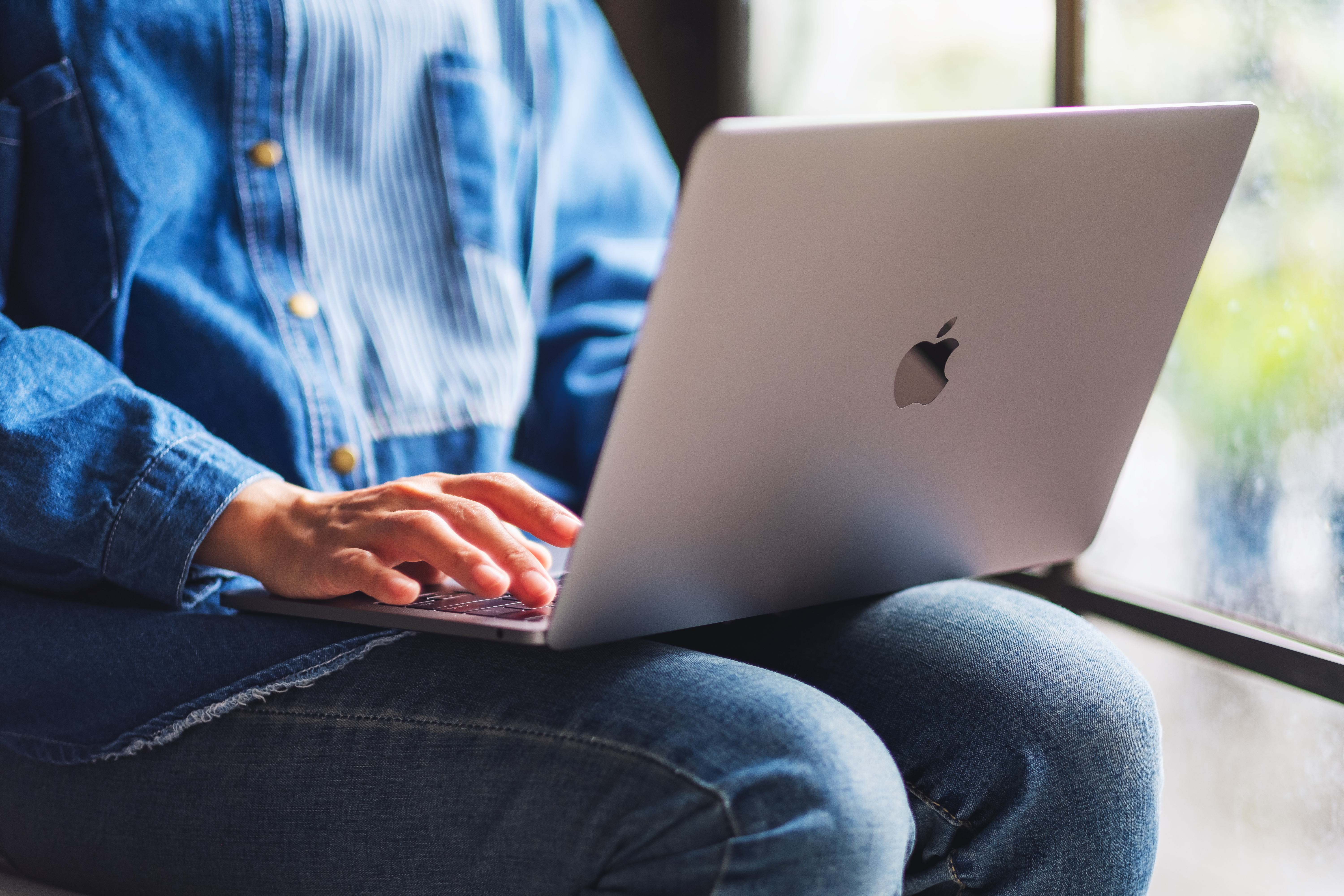 Person working on an Apple MacBook