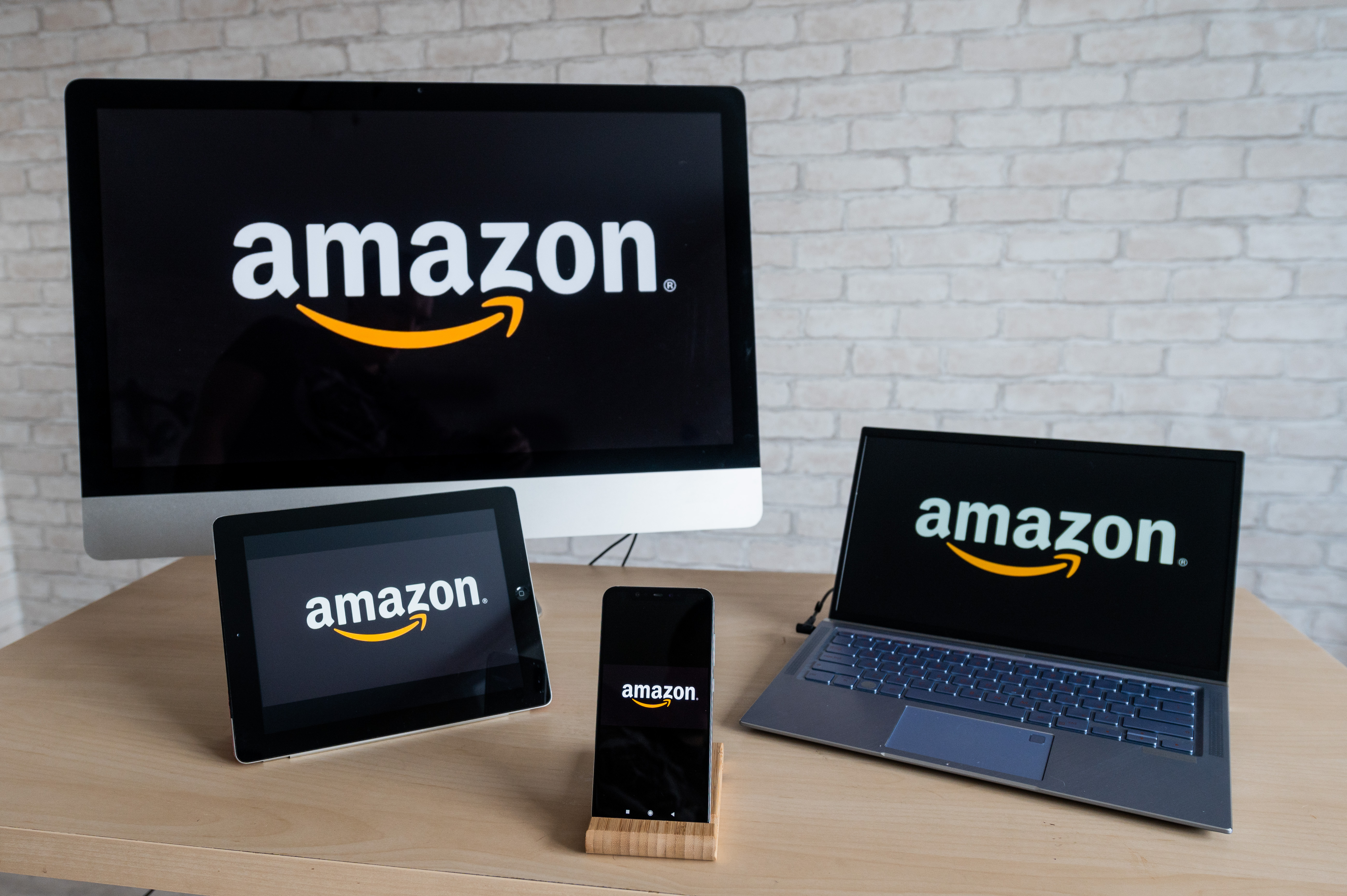 Various electronic devices displaying the Amazon logo
