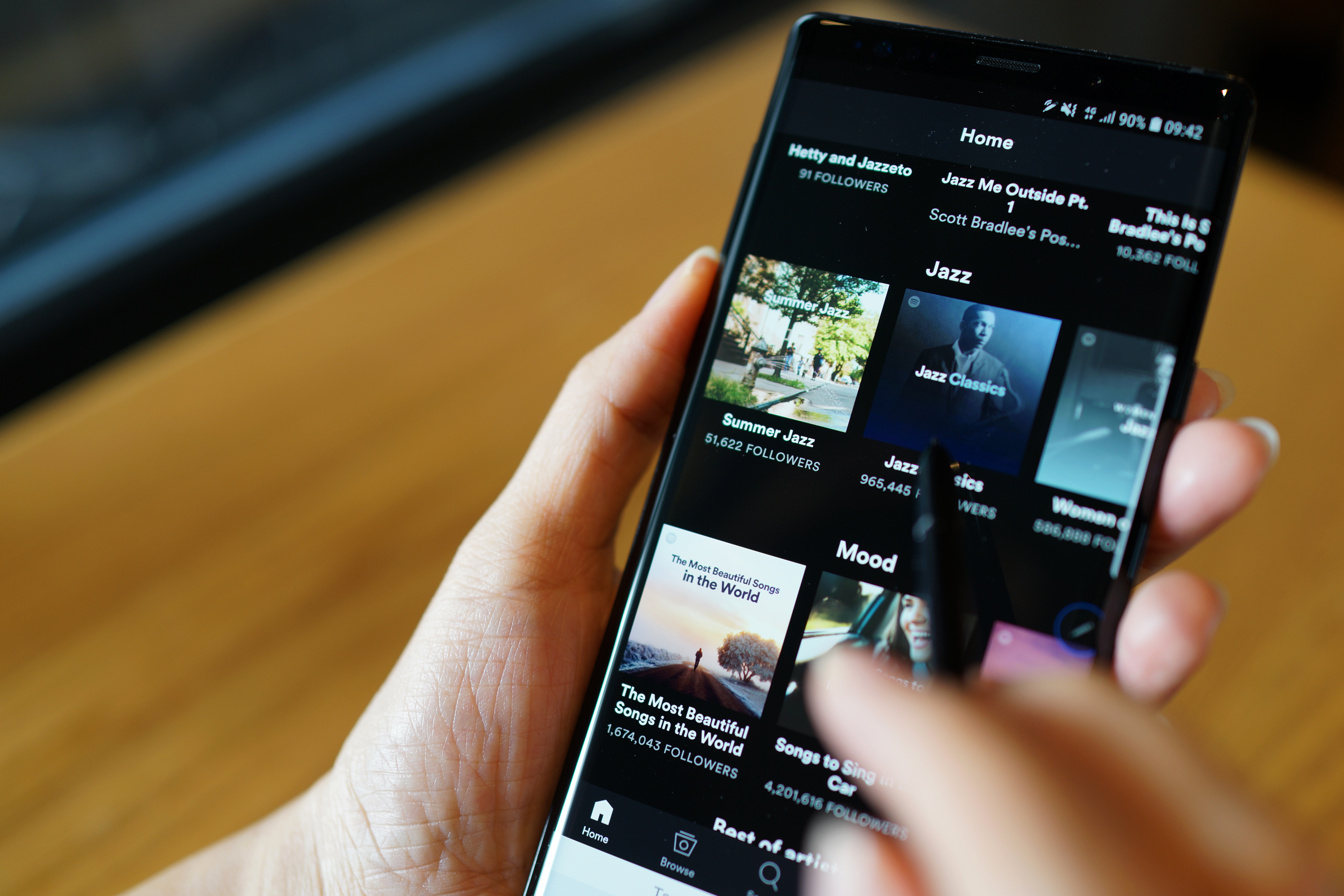 Woman scrolling through Spotify on her smartphone