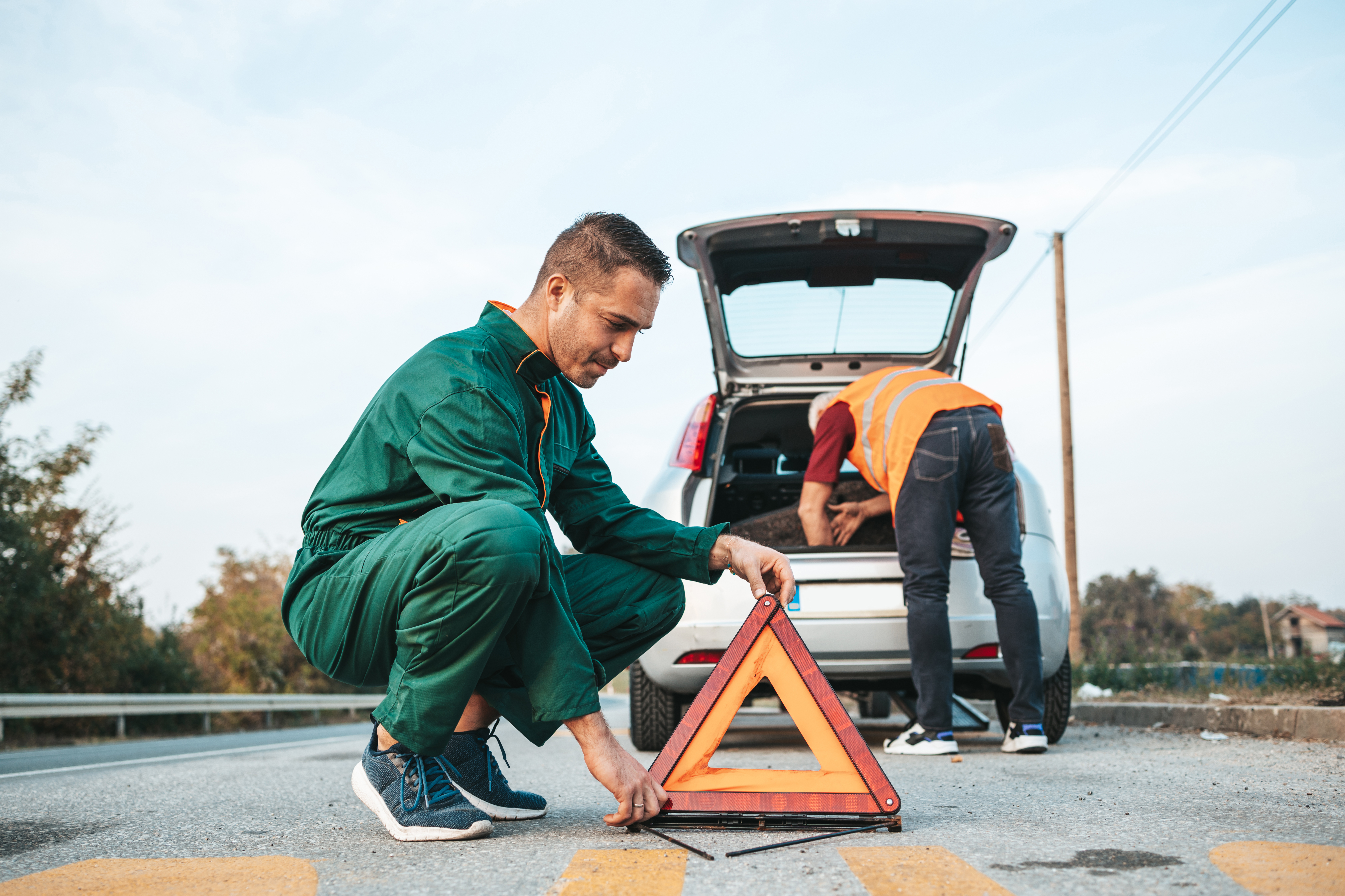 Two men setting up to assist with a roadside emrgency