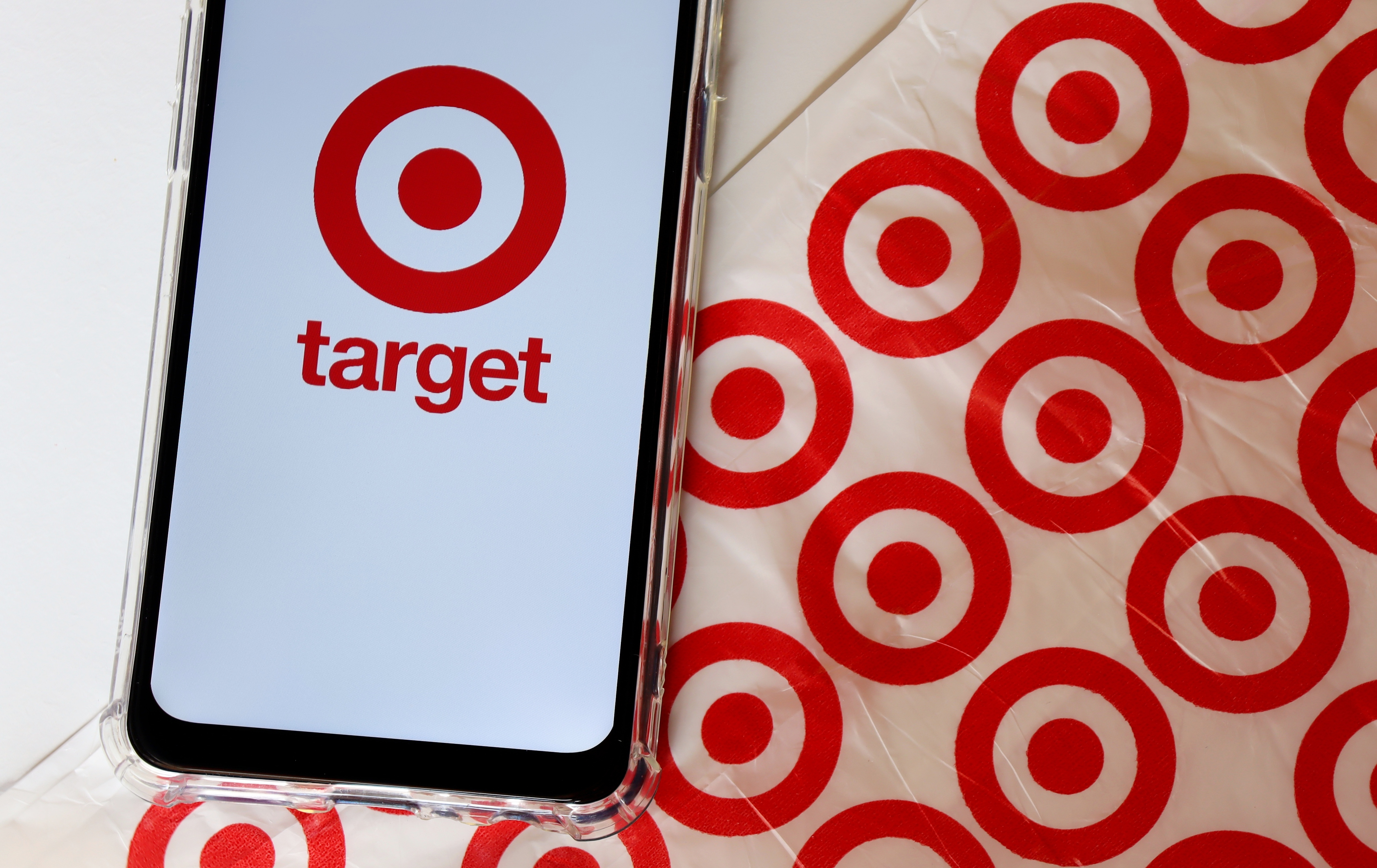 A smartphone displaying the Target logo next to a Target shopping bag