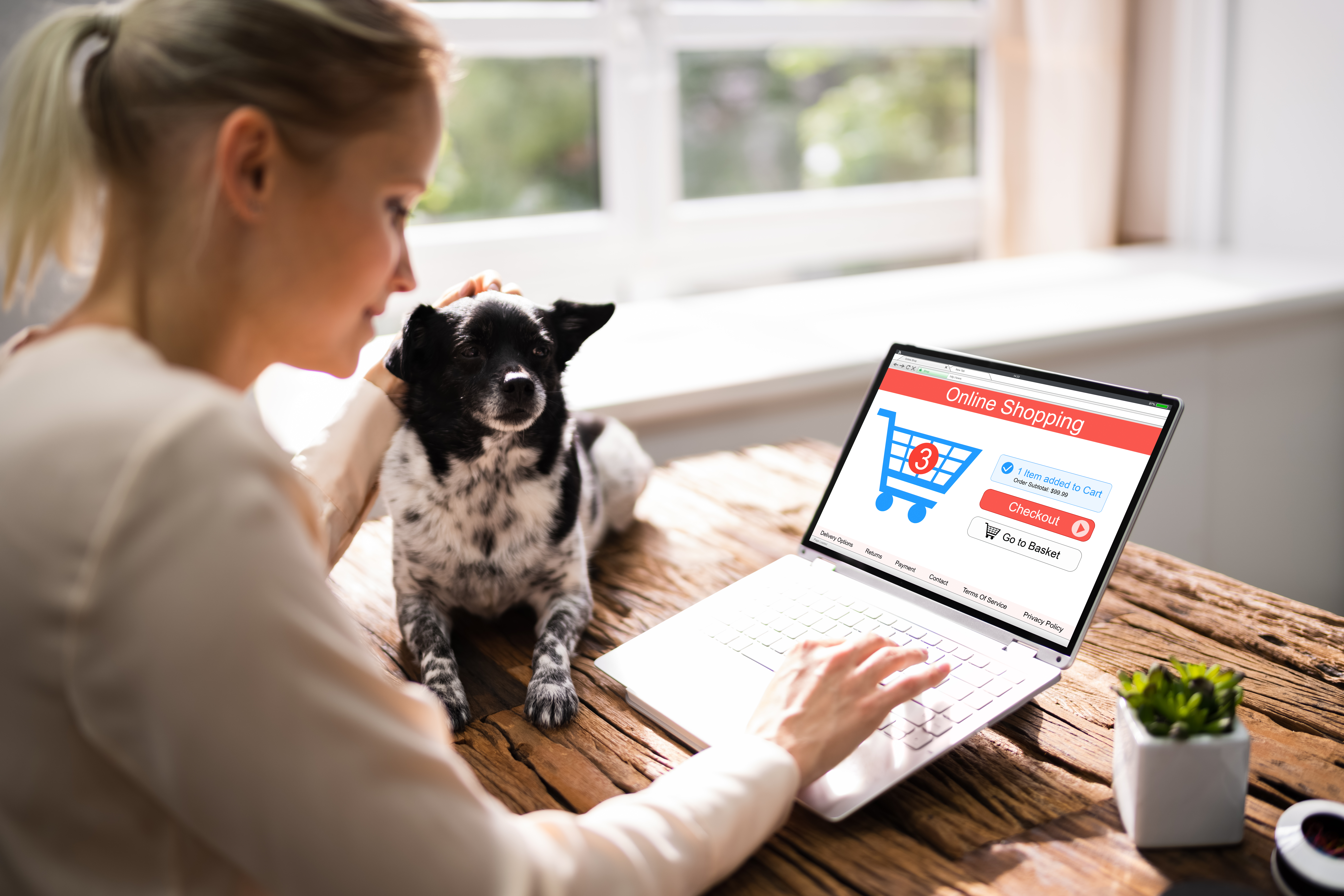 Woman shopping online while petting her dog