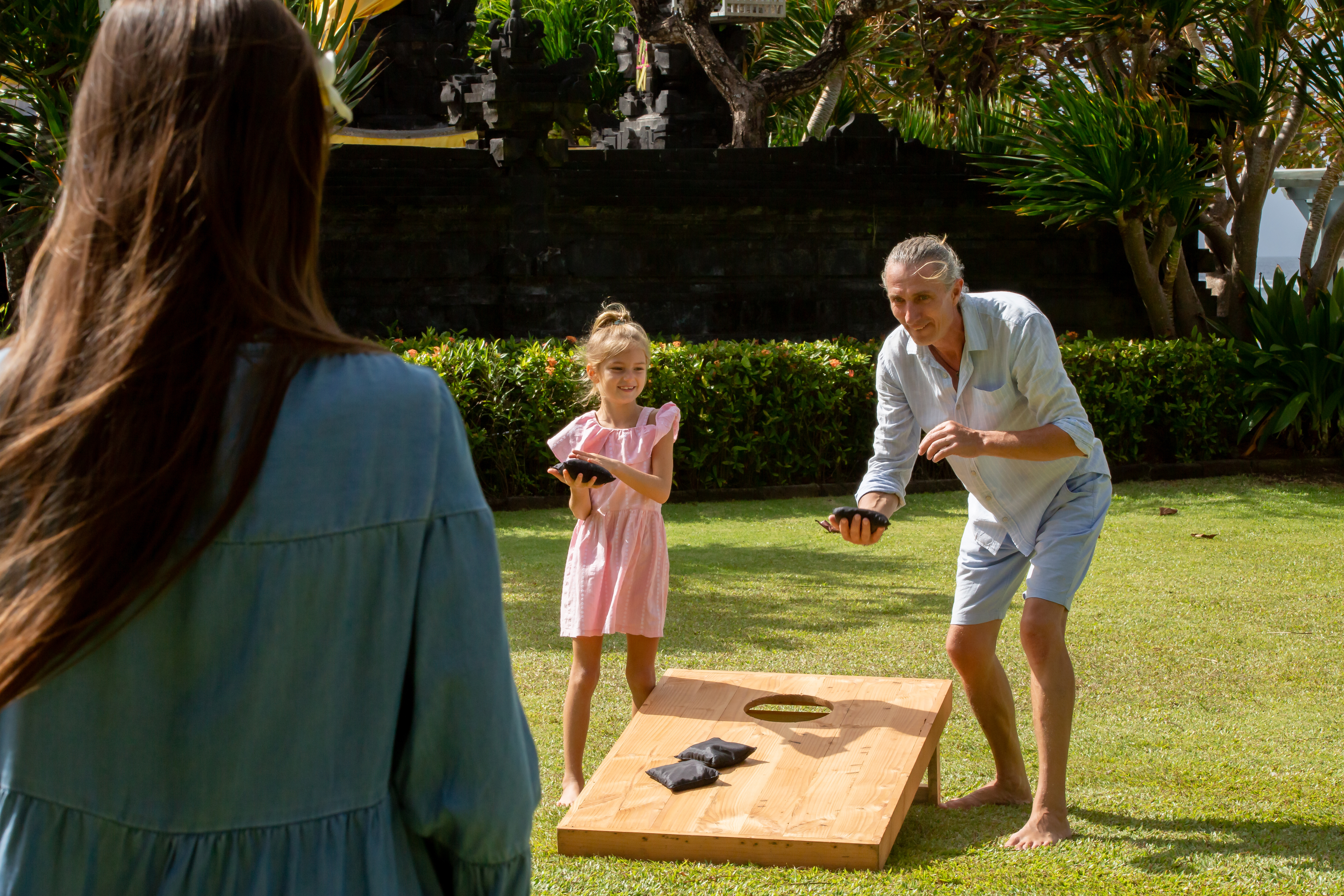 Man and child playing cornhole