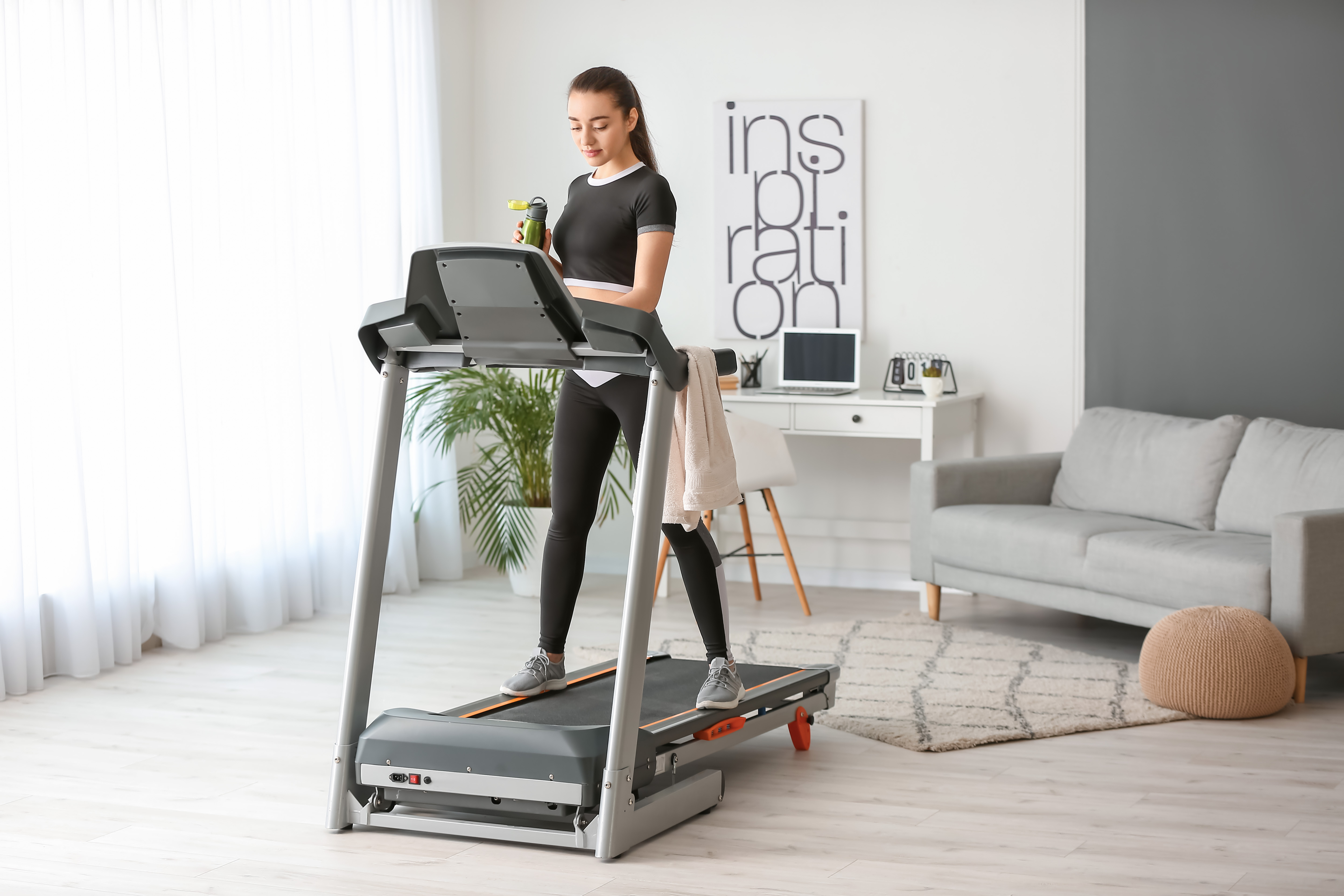 Woman standing on a treadmill at home