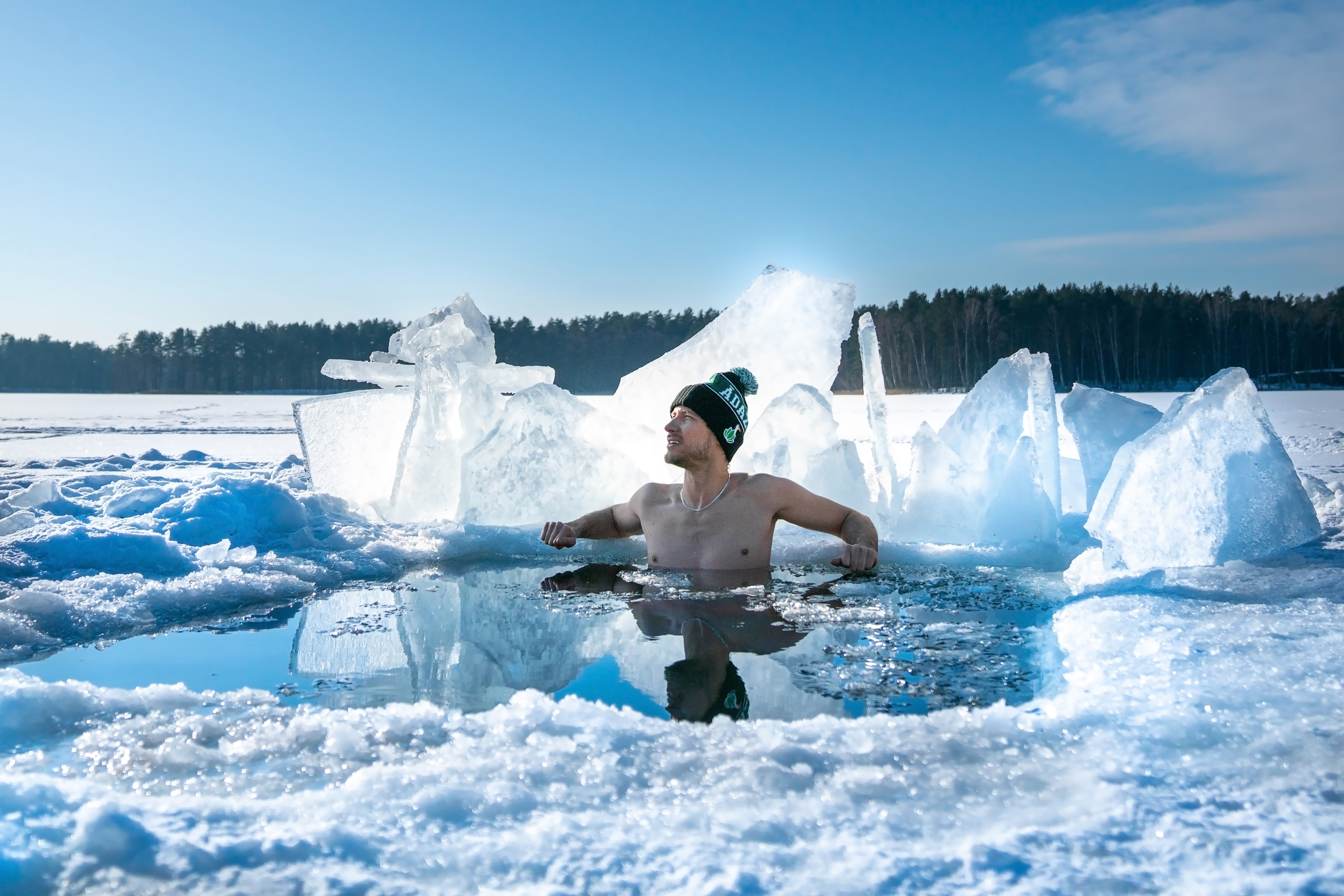 Man submerged in water in a frozen lake