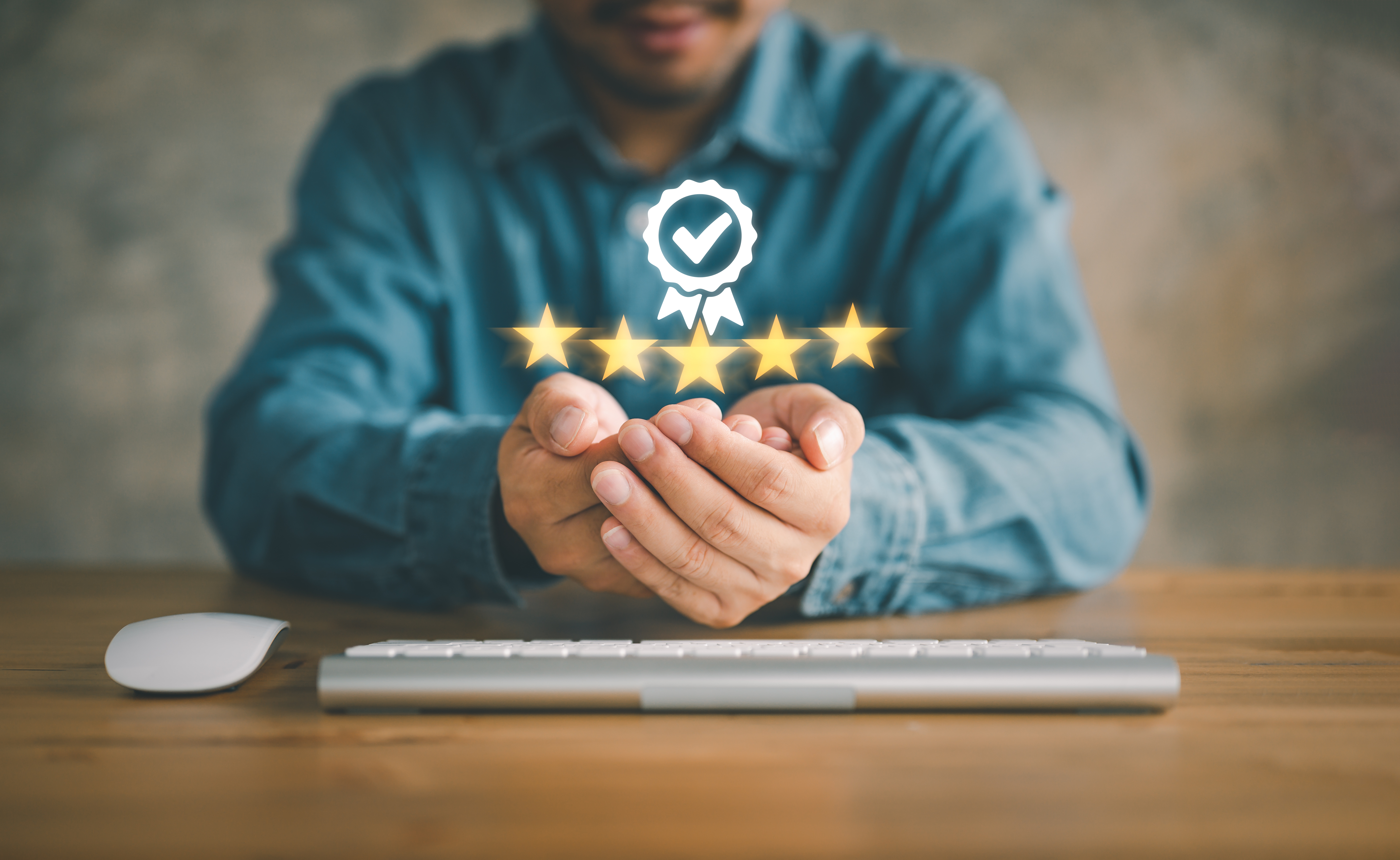 Person sitting at a table holding their hands open with a 5-star logo above them