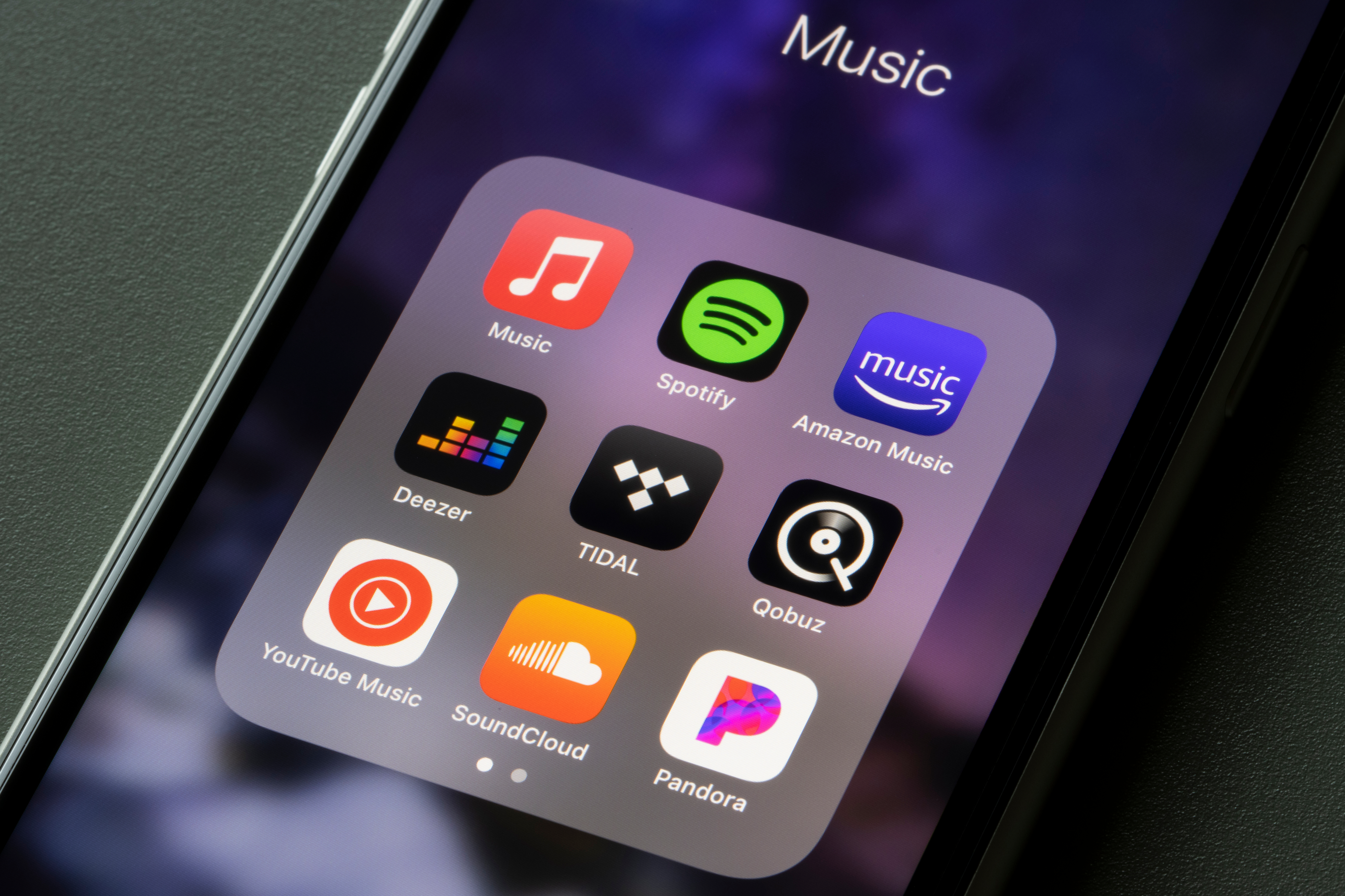 Smartphone showing various music streaming apps