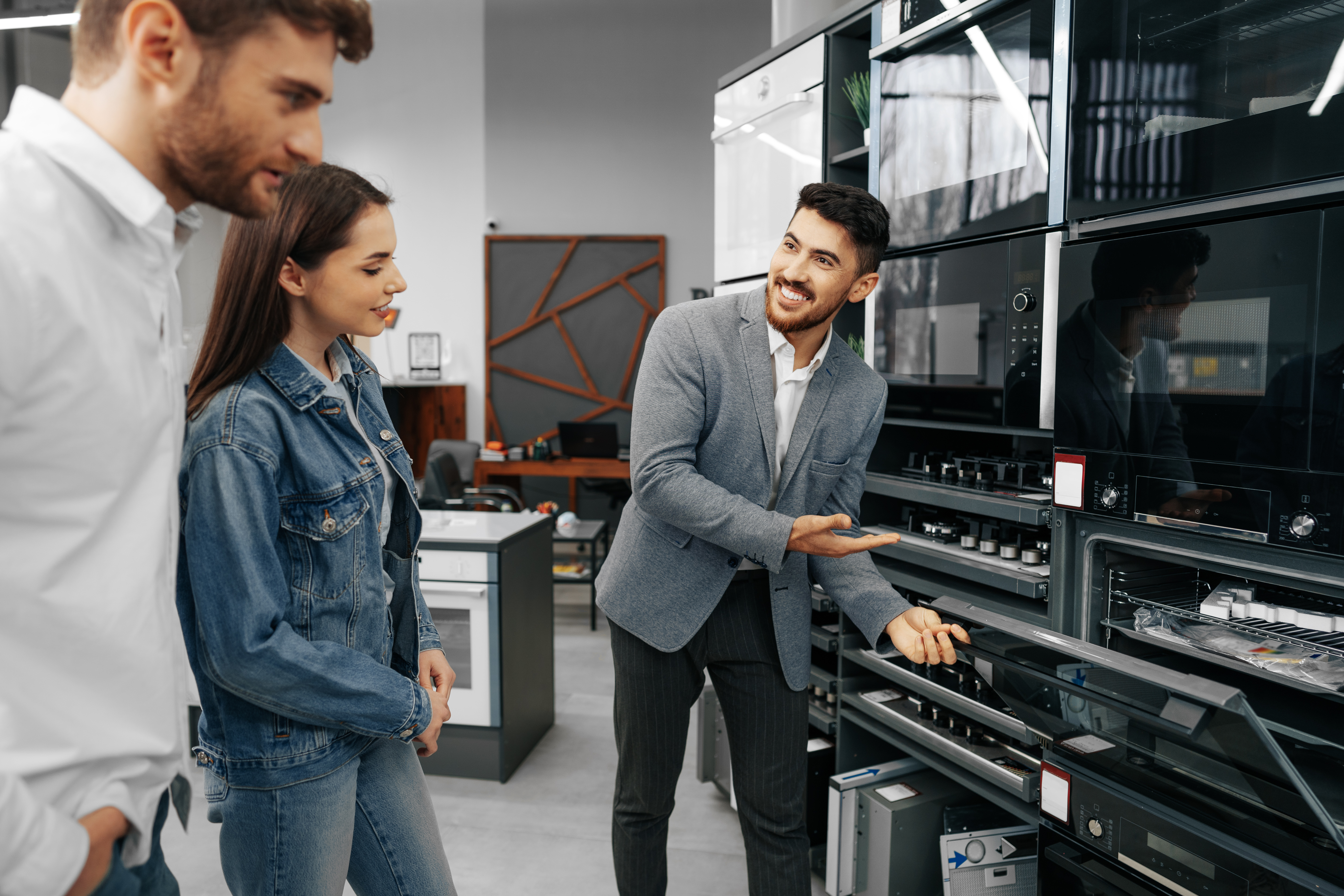 Man showing a couple a new oven