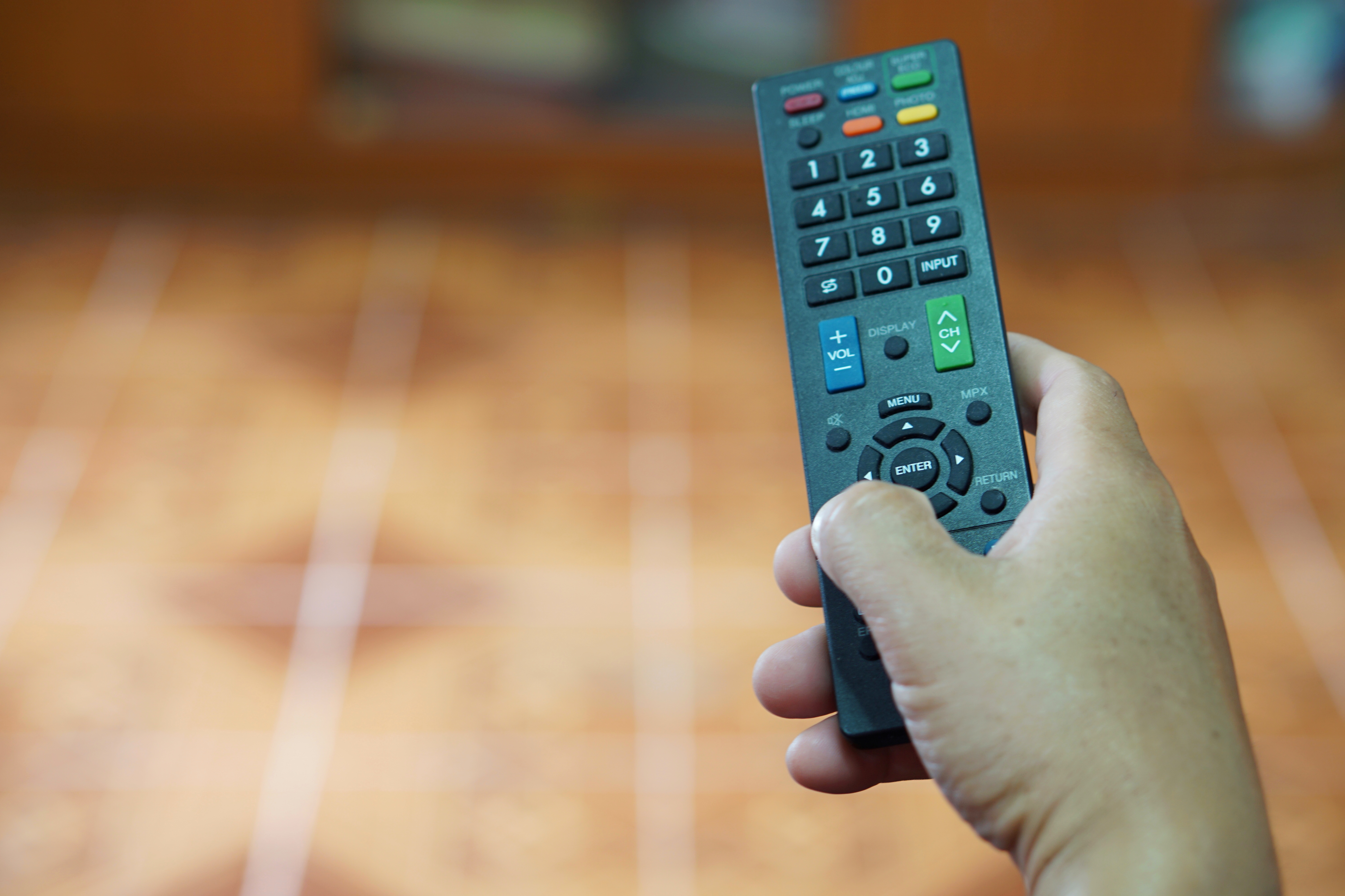 Person holding up a universal remote