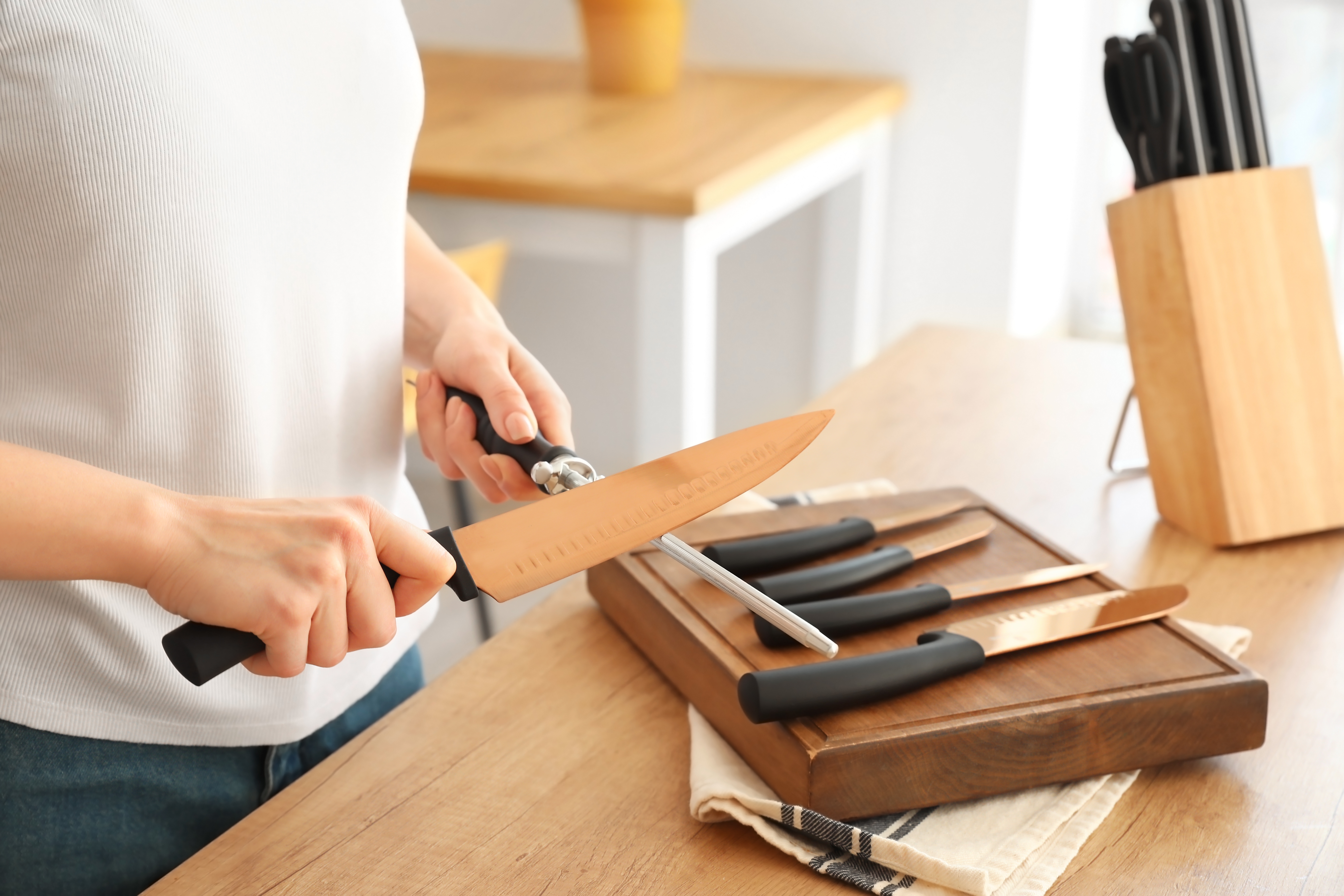 Person sharpening a knife from a set