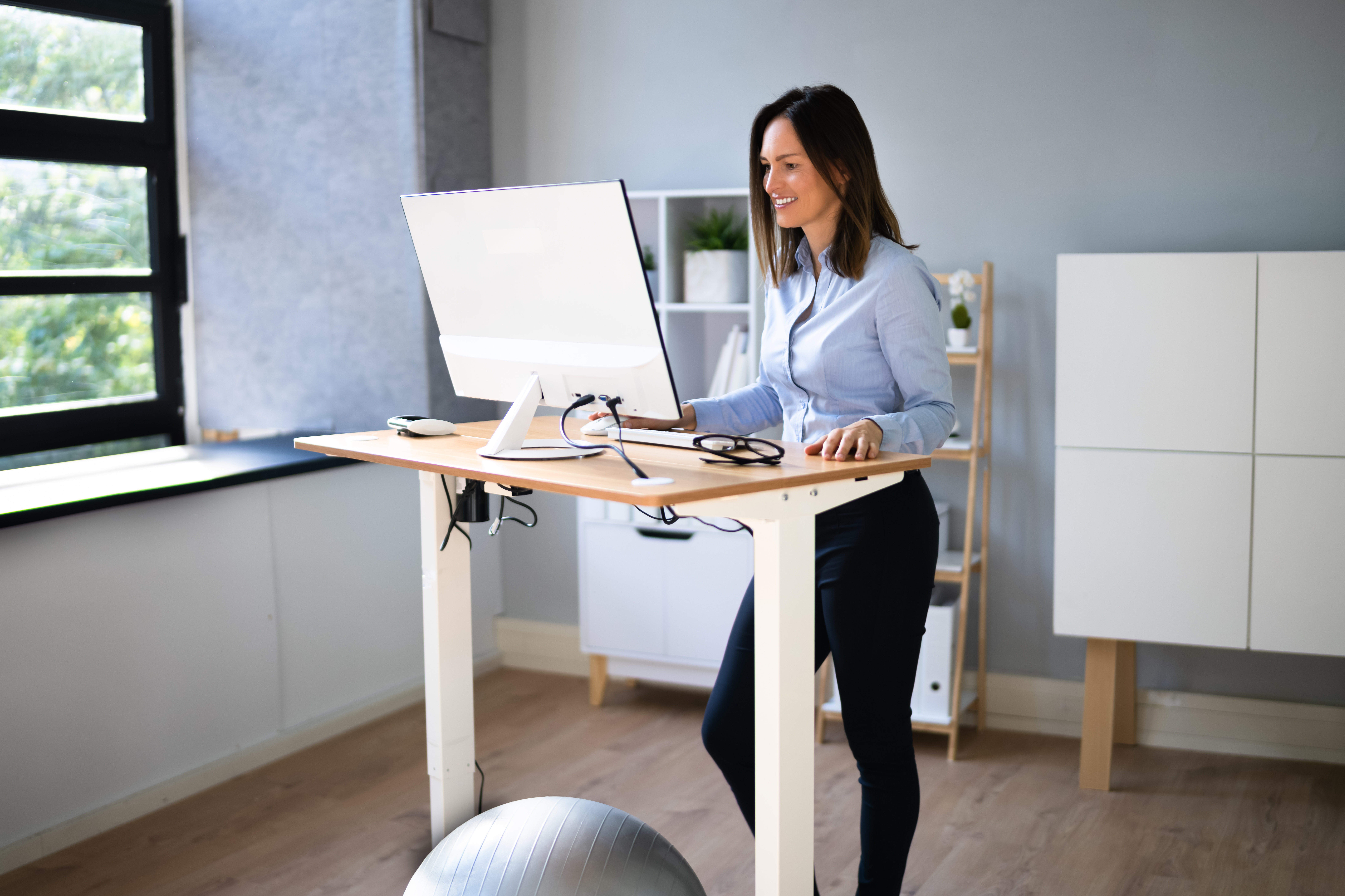 Woman standing and working at a standing desk