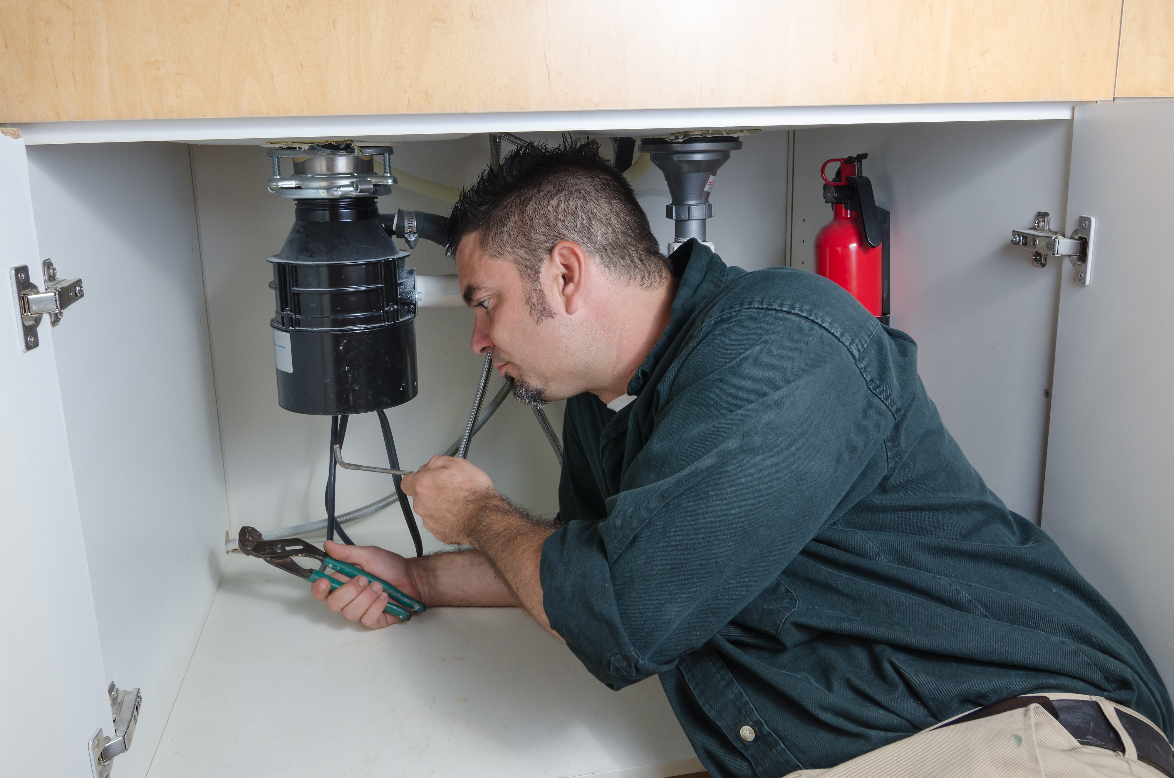 person trying to fix garbage disposal