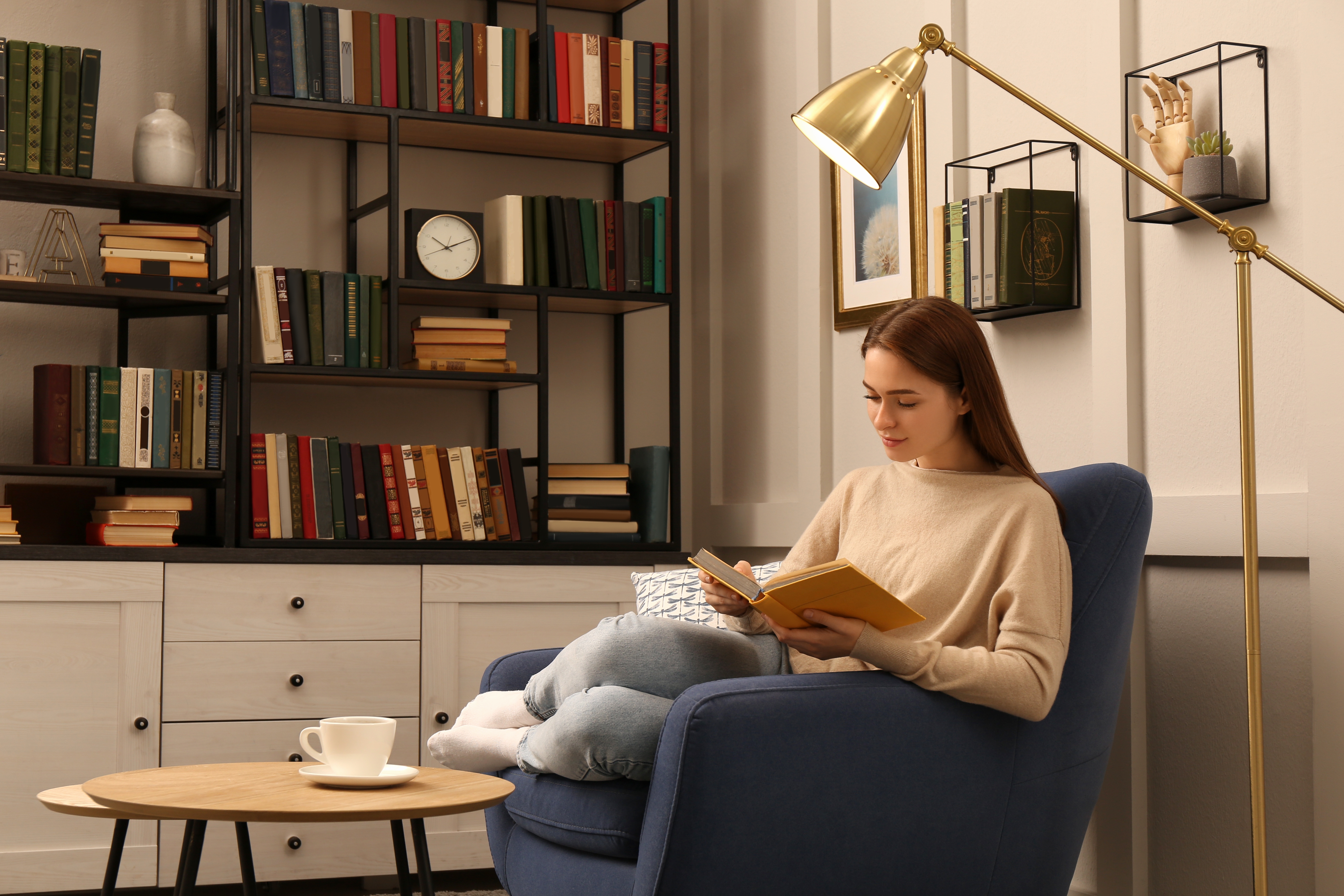 Woman lounging on blue chair in home office