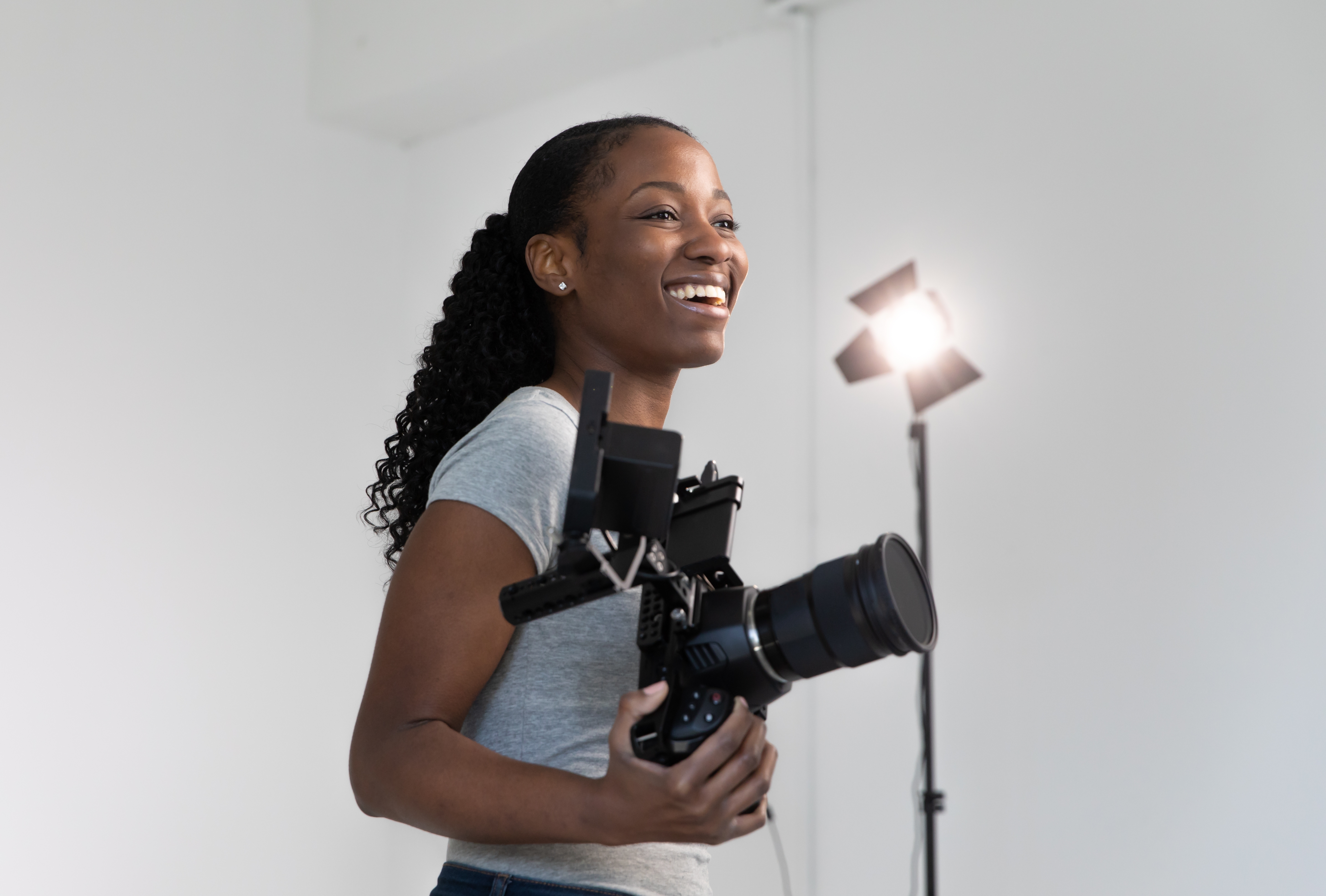 Woman smiling holding a video camera