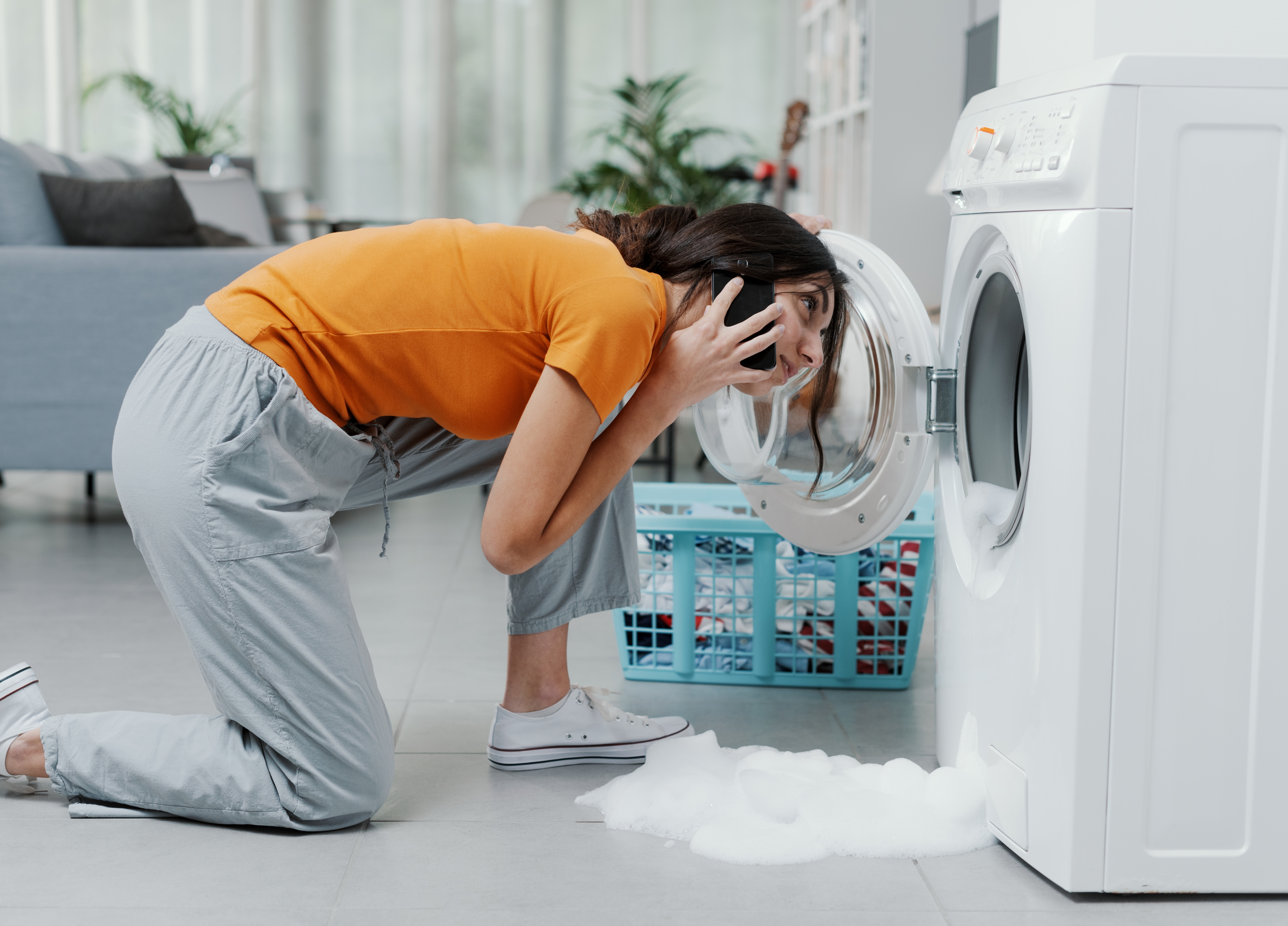 woman looking into overflowing washer