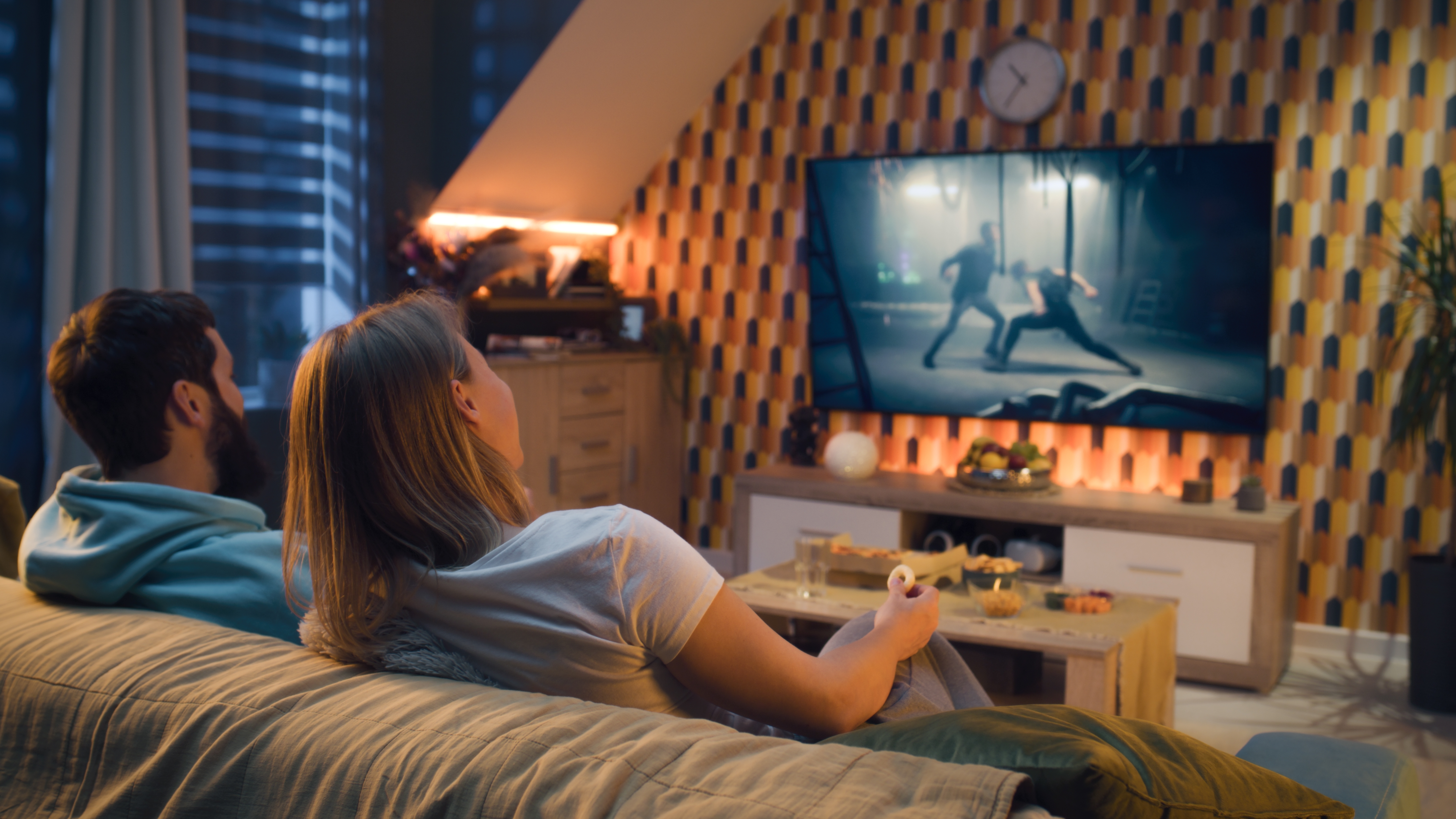 Couple sitting on the couch watching a movie