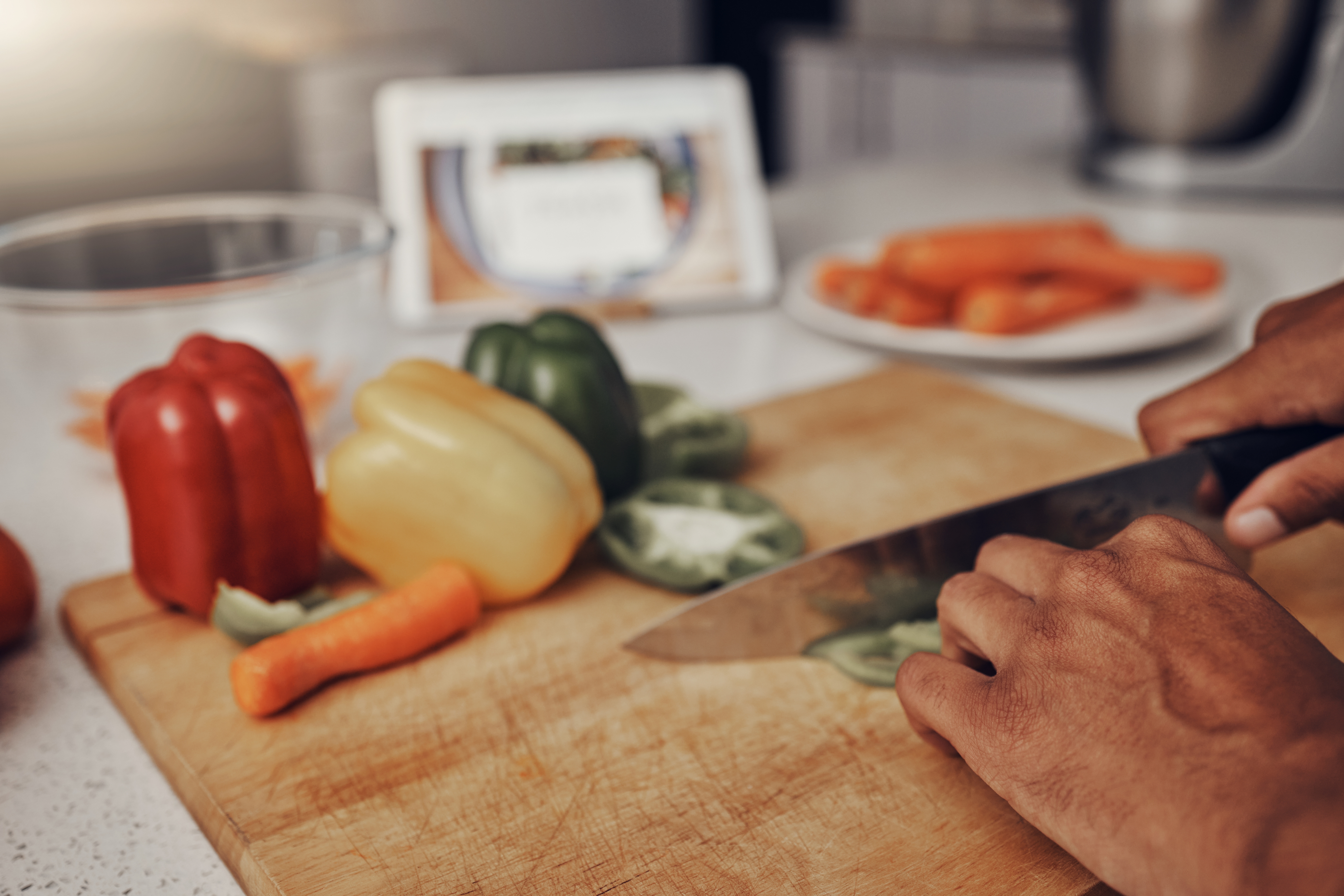 Person chopping vegetables on a wood cutting board