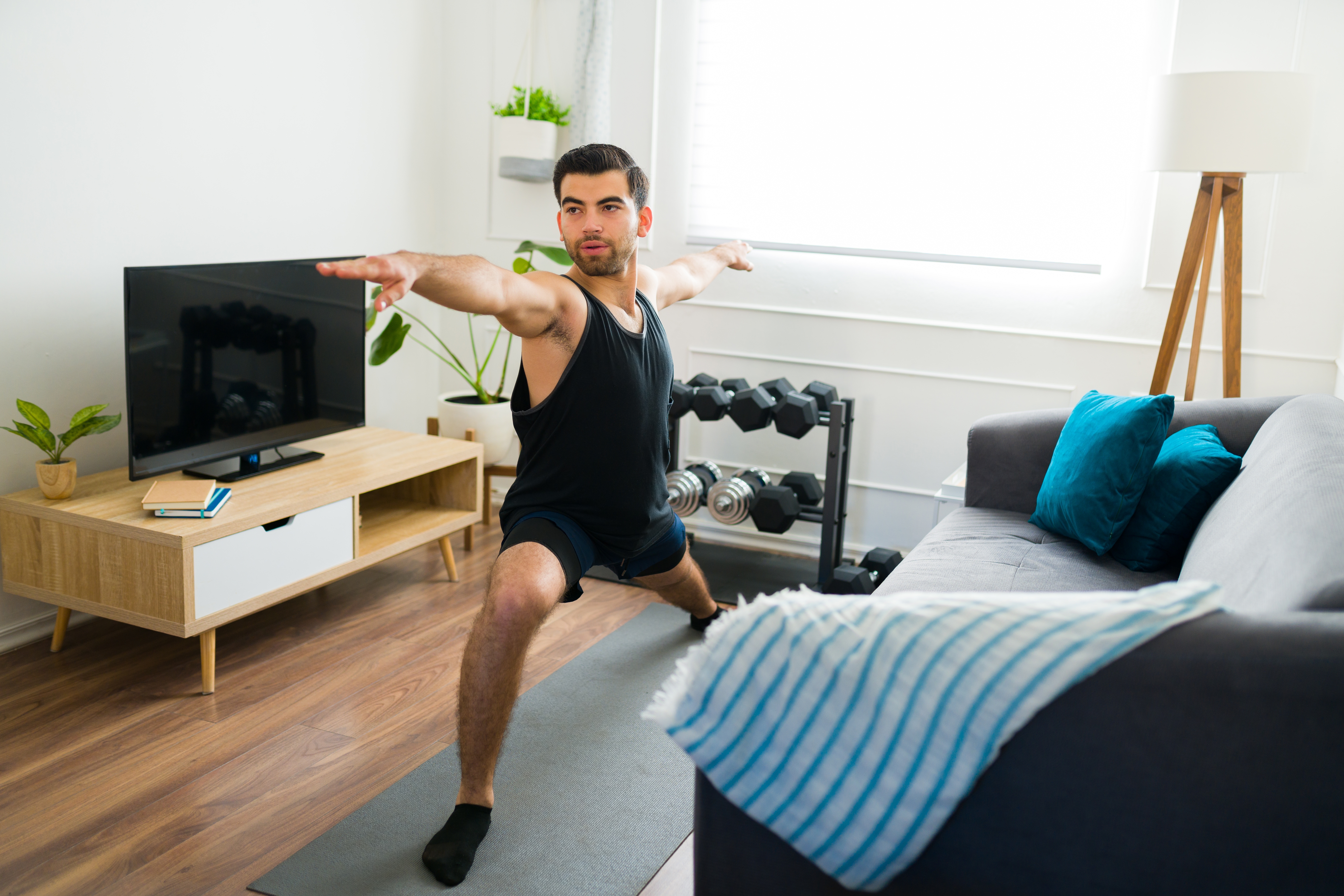 Man doing a yoga pose in his home