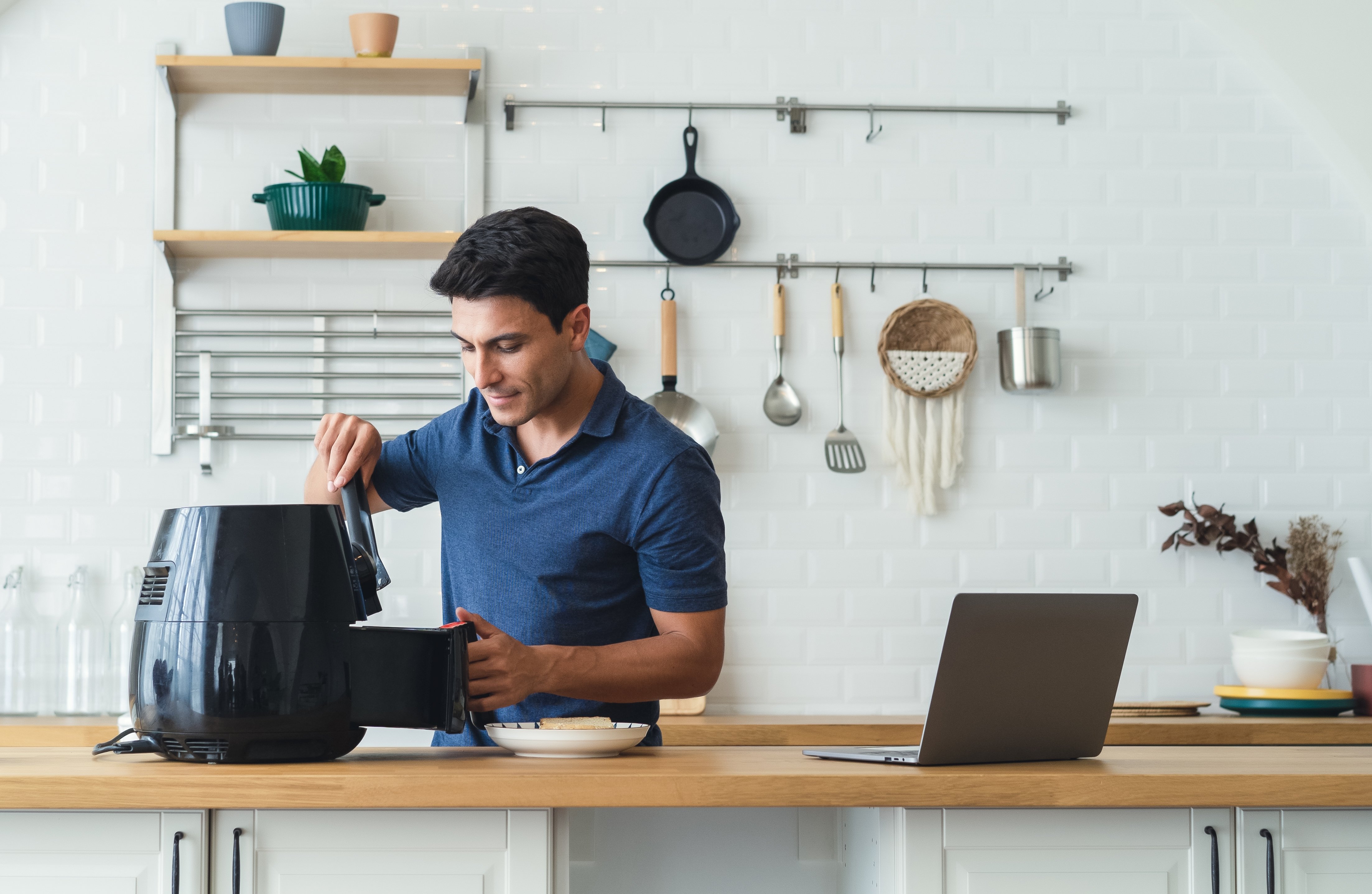 Man using an air fryer