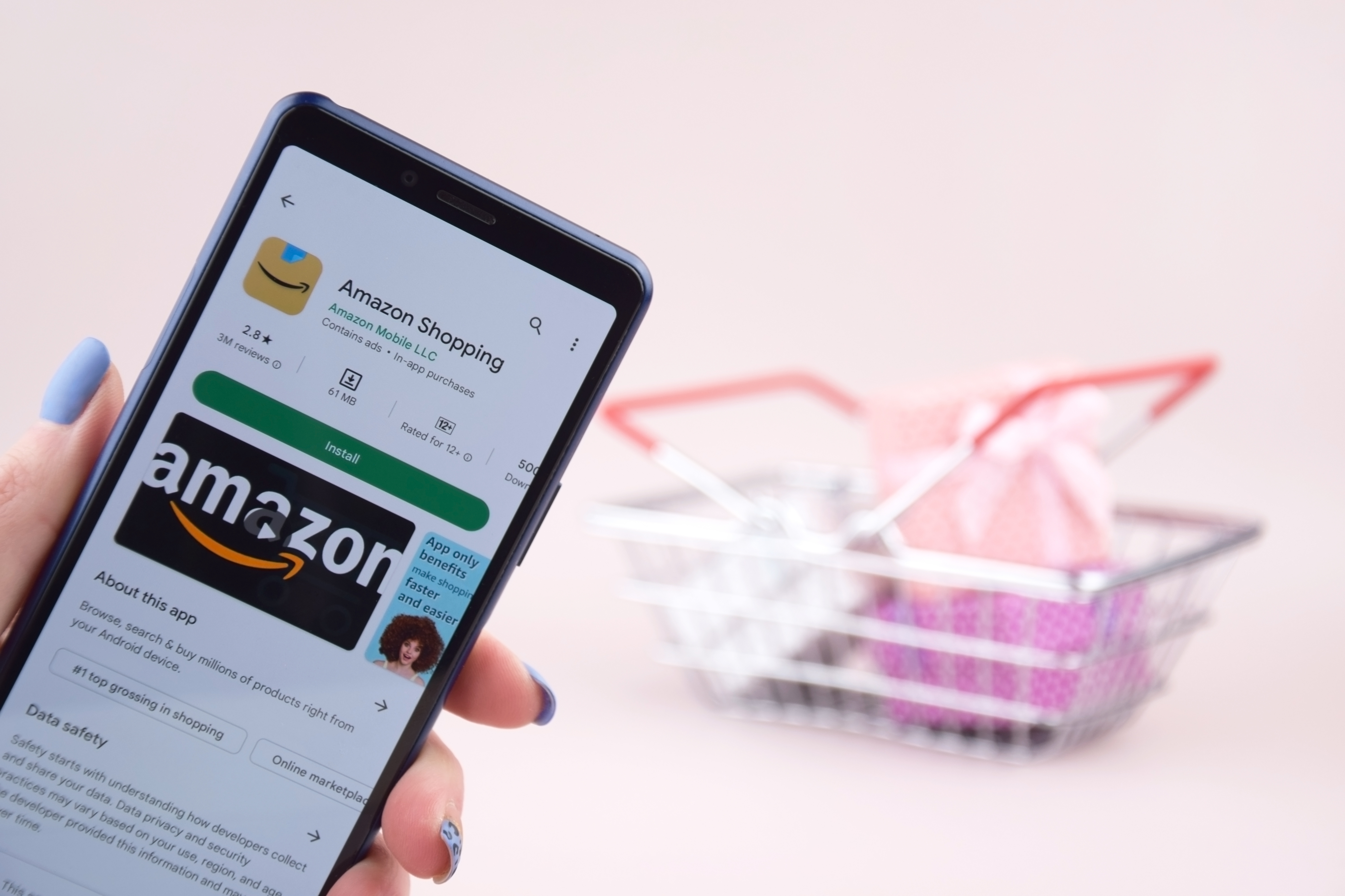 Person holding a smartphone with the Amazon shopping app on it