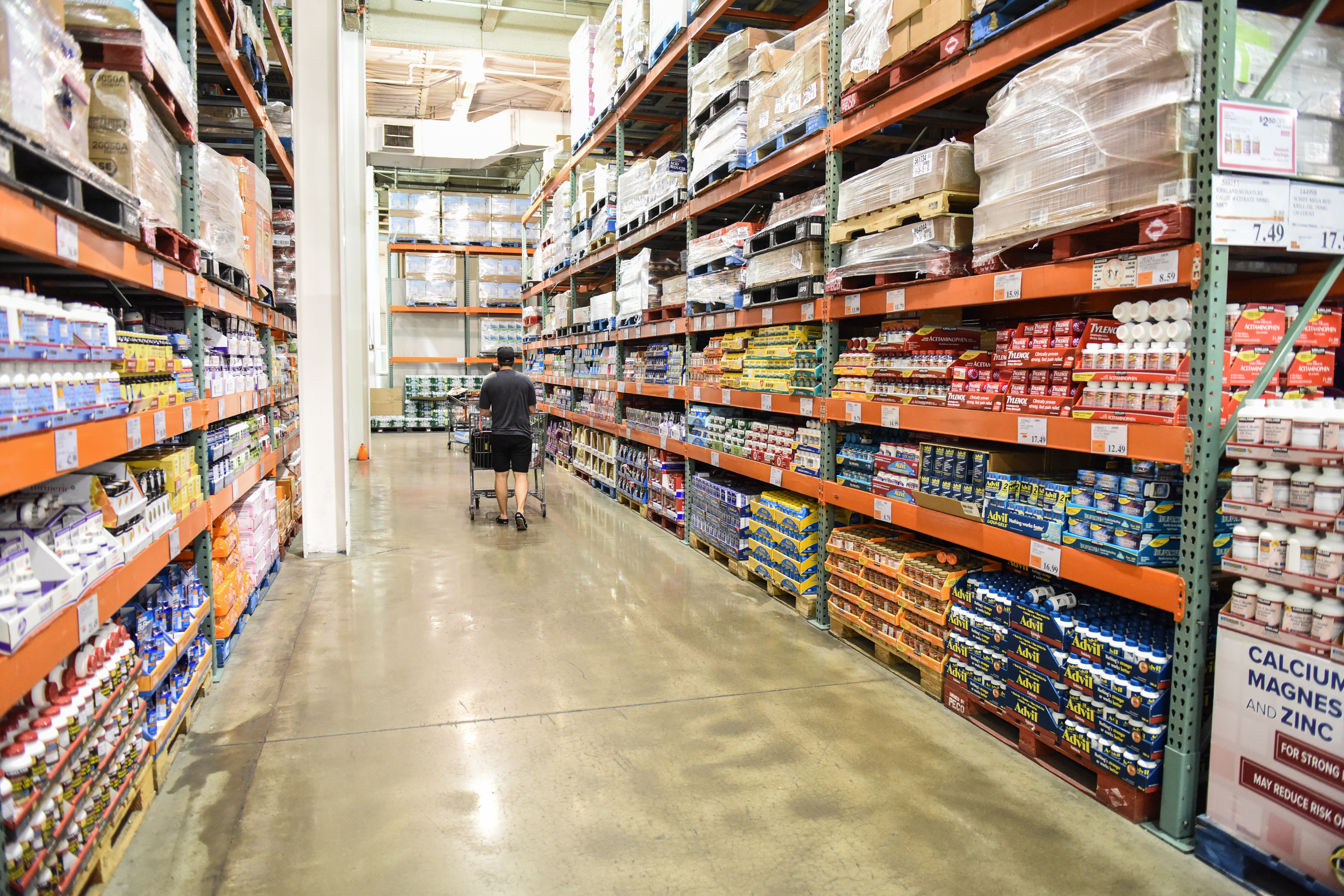 Man walking down the aisle of a warehouse store