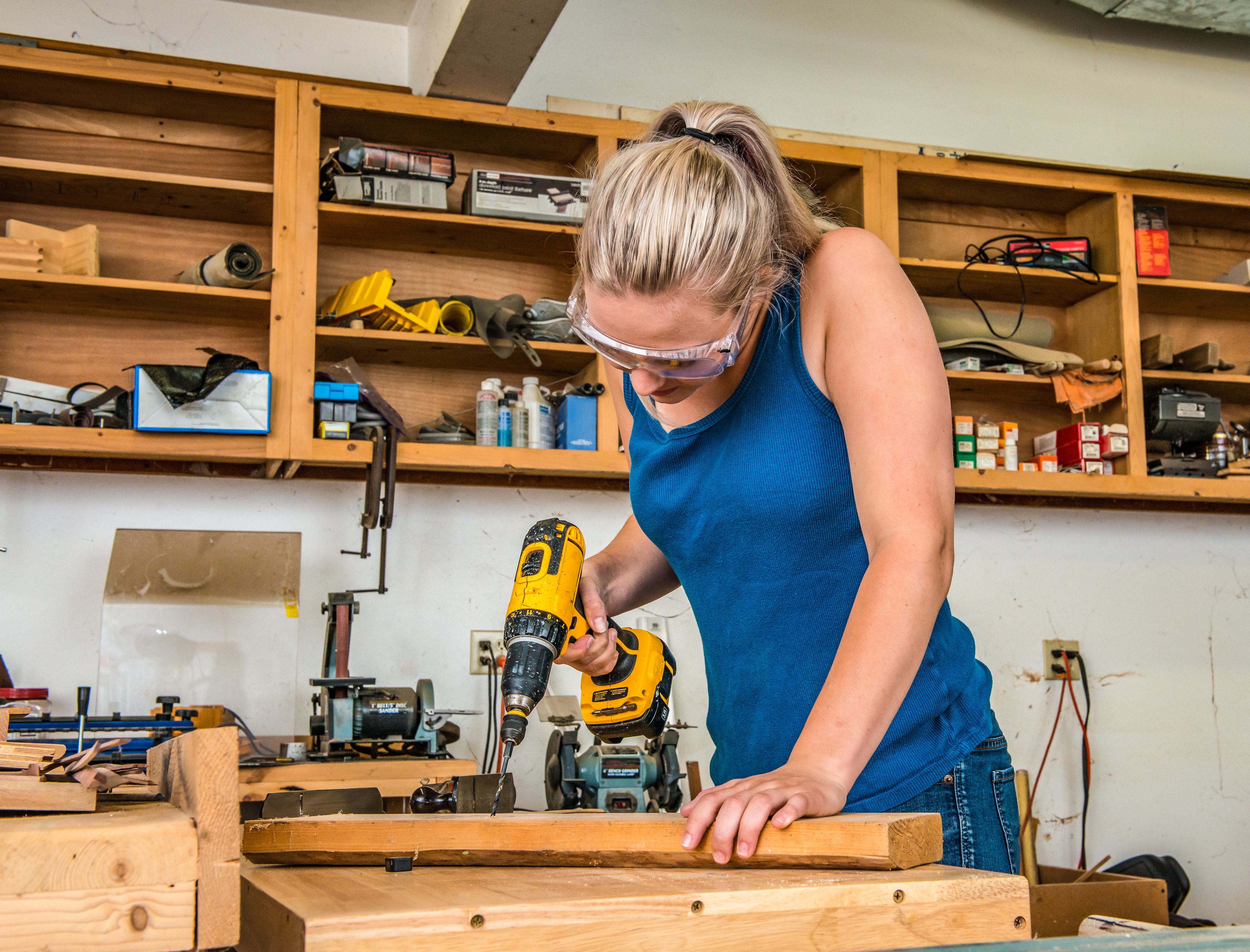 person using drill in workshop