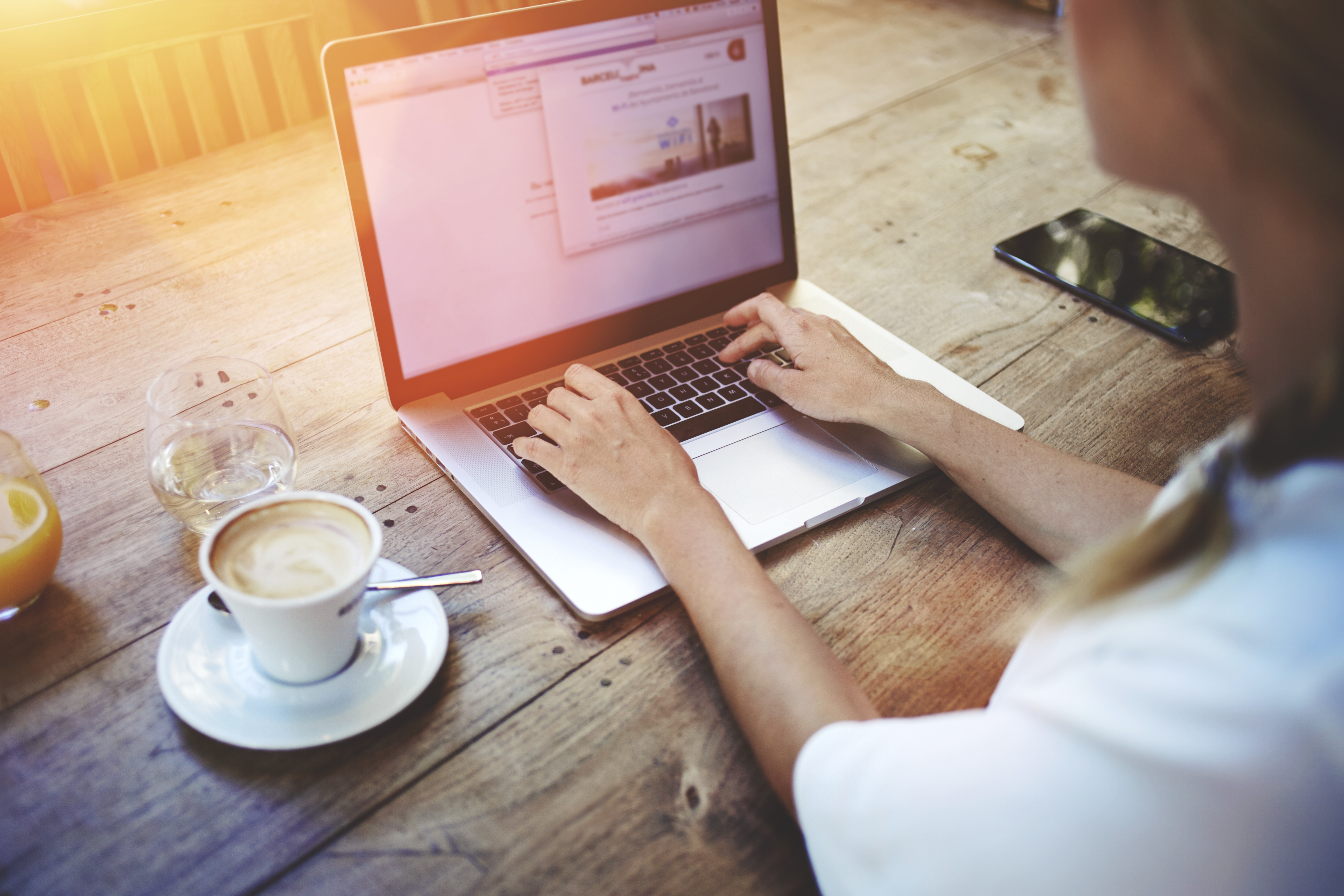 Woman using her laptop at a coffee shop