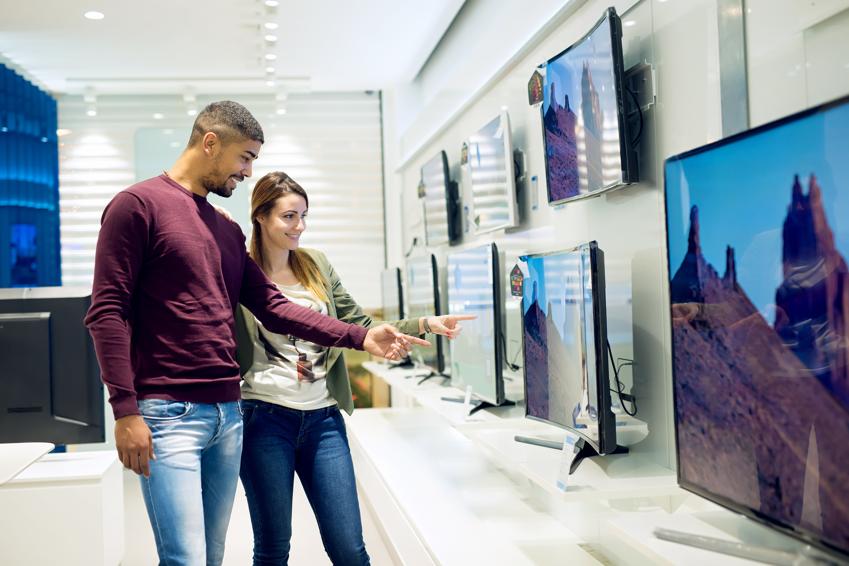 Man and woman shopping for a TV
