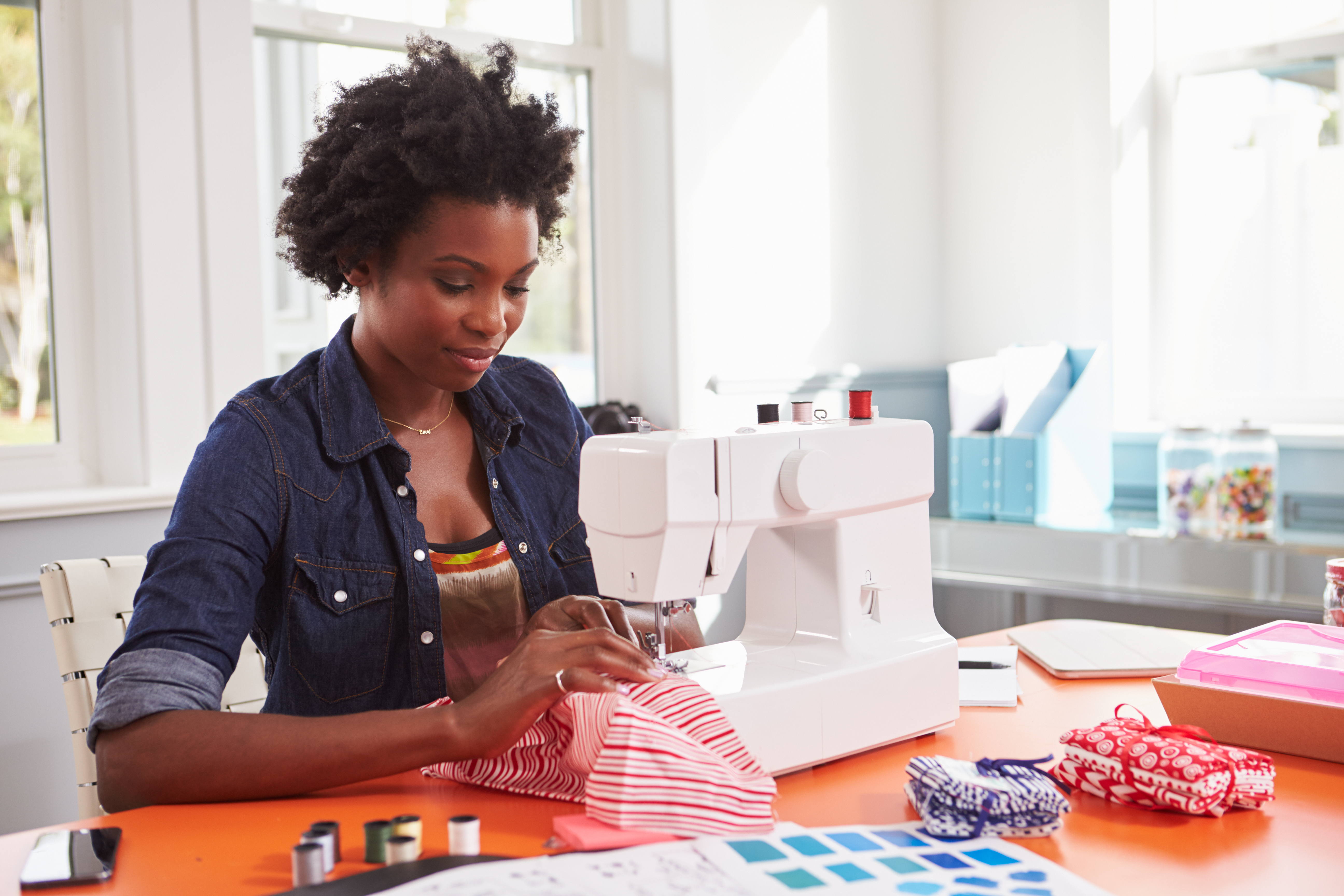 Woman sitting at a sewing machine