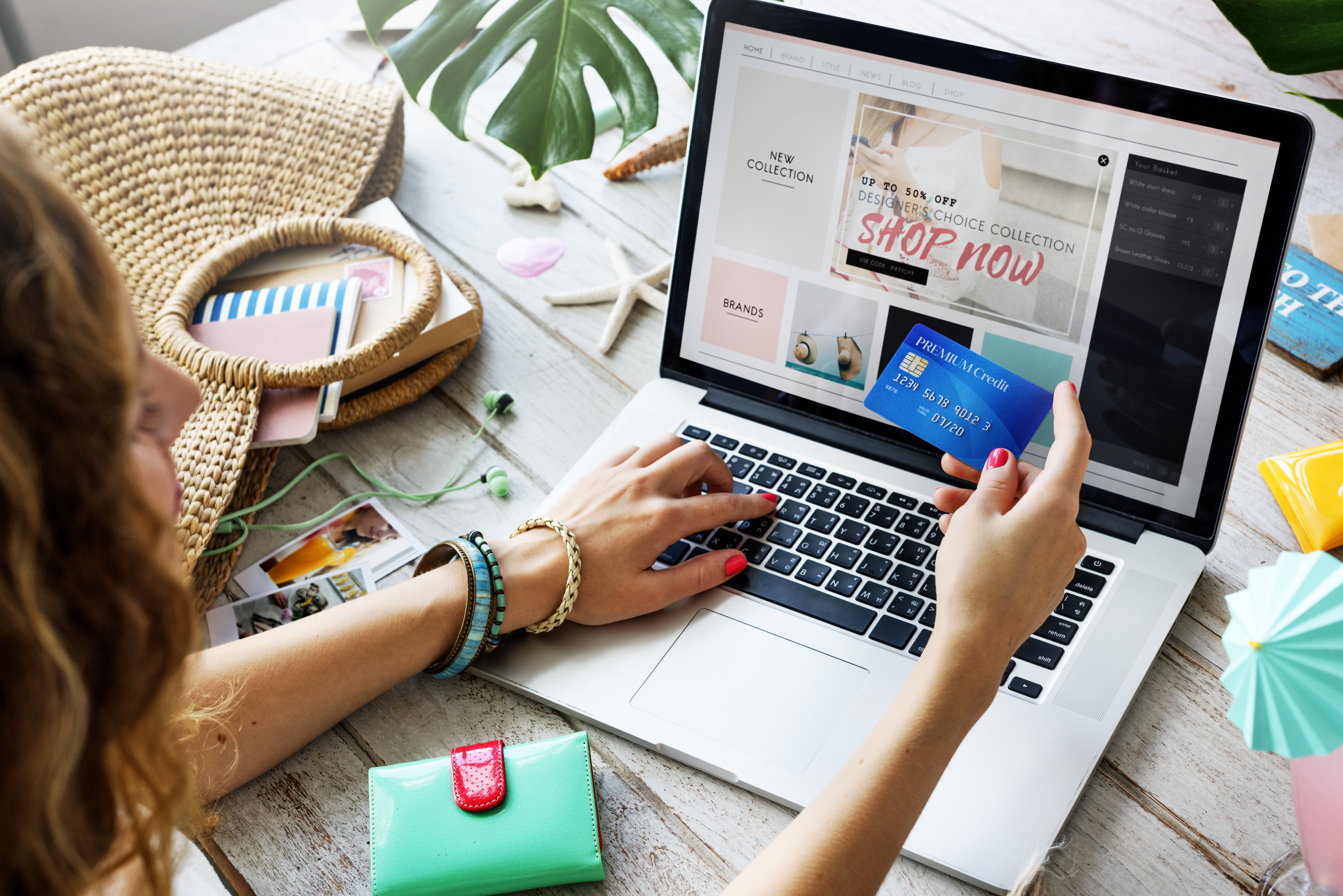 Woman using her credit card to pay for a sale item on her laptop